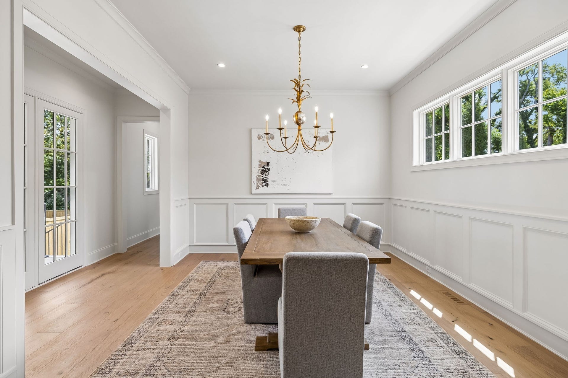 1133 Maplehurst Ln, Nashville, TN 37204 Elegant formal dining room is filled with natural light and finished with detailed wall molding, hardwood floors, and statement lighting