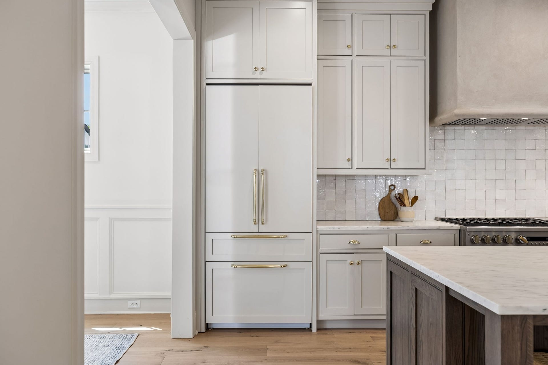 1133 Maplehurst Ln, Nashville, TN 37204 Floor-to-ceiling cabinetry provides exceptional storage while integrated appliances, brass hardware, and handcrafted tile add to the kitchens refined custom design.