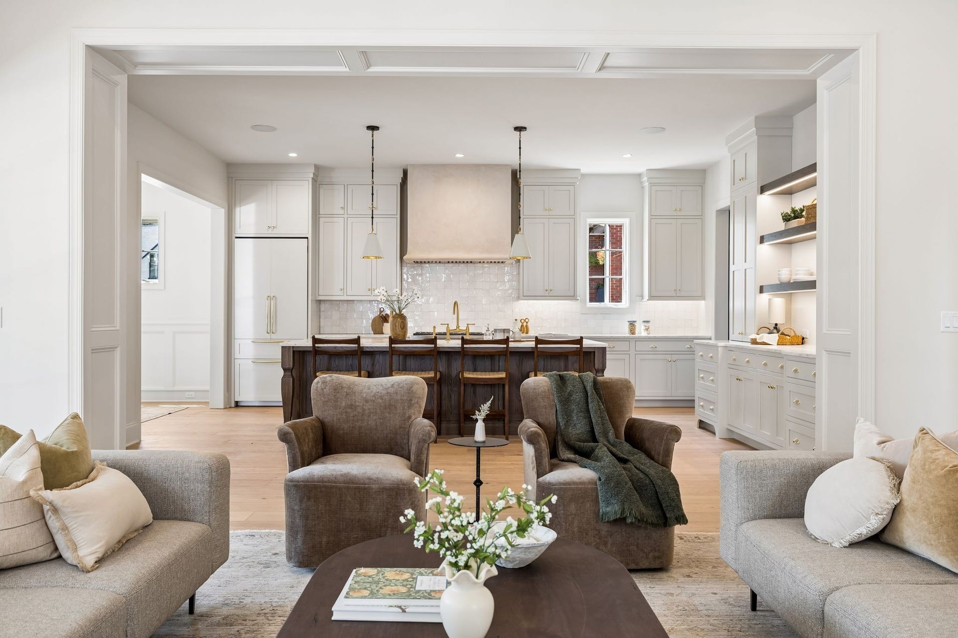 1133 Maplehurst Ln, Nashville, TN 37204 A wide architectural opening connects the great room and kitchen while maintaining definition between the spaces. Thoughtful millwork and abundant natural light elevate the open-concept design.