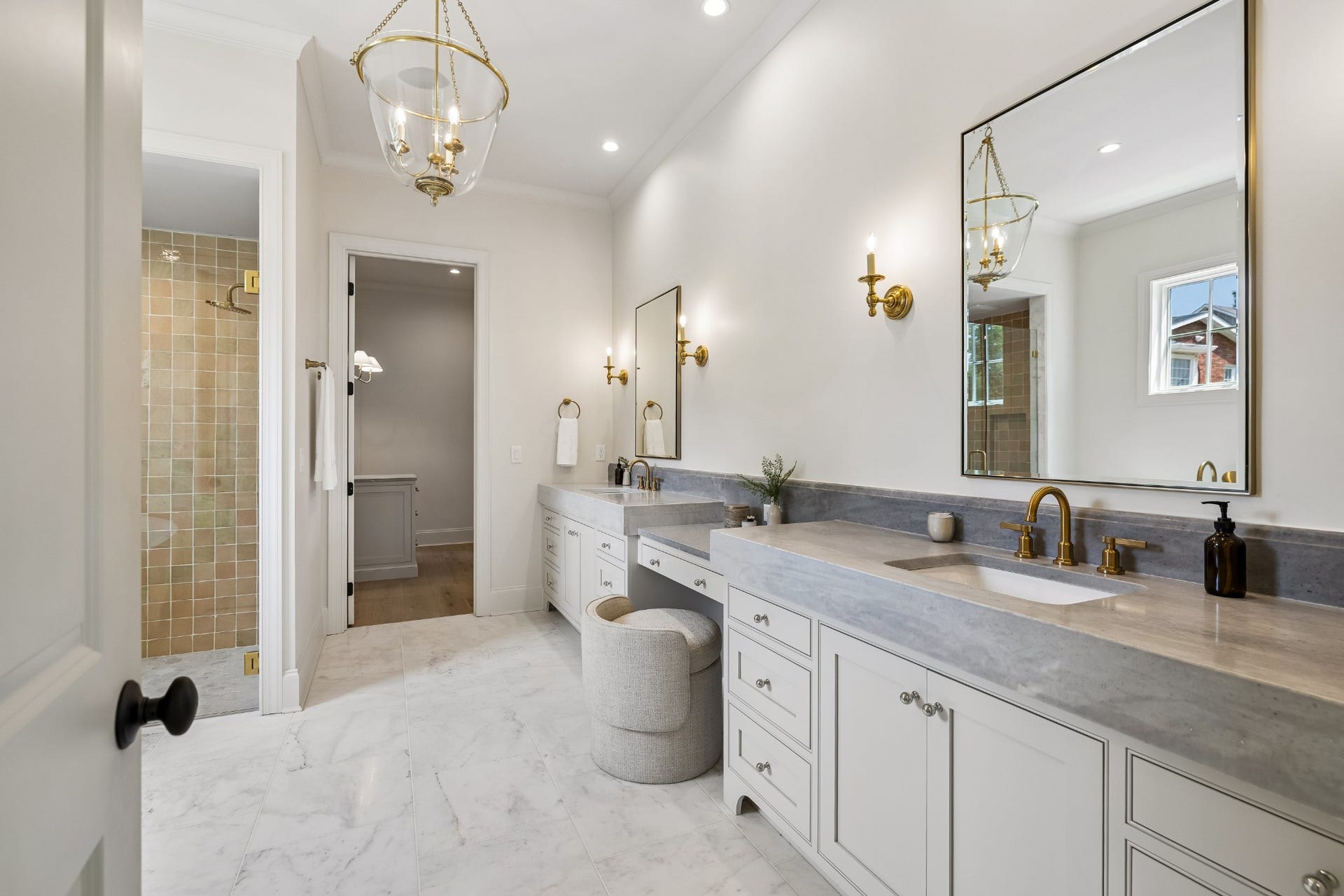 1133 Maplehurst Ln, Nashville, TN 37204 Thoughtfully designed primary bath offers expansive vanity space, designer lighting, beautiful stone surfaces, and direct access between the bath and primary suite.