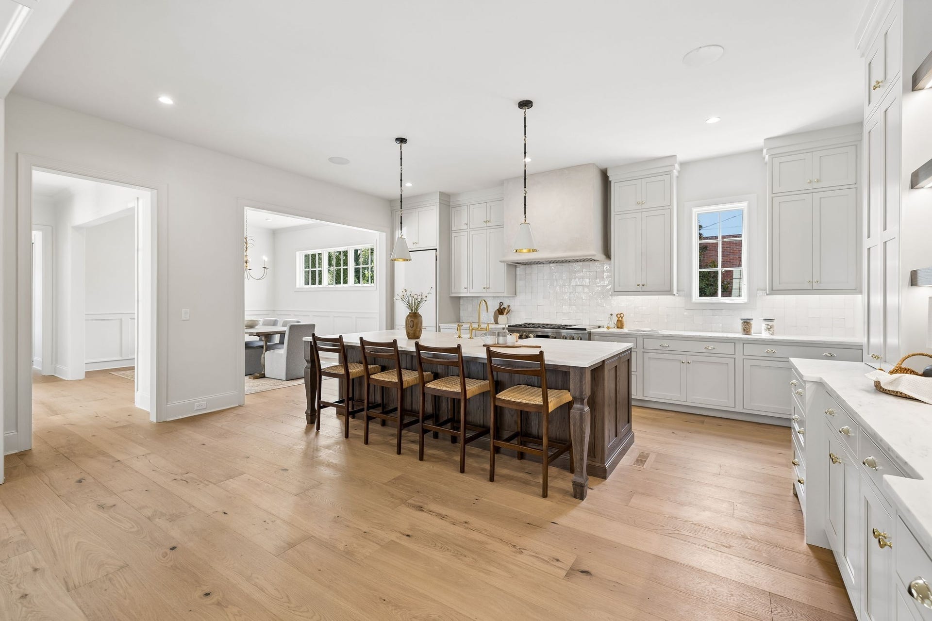 1133 Maplehurst Ln, Nashville, TN 37204 Spacious chefs kitchen combines an oversized island, custom cabinetry, statement range hood, designer lighting, and generous workspace with an open connection to the dining and living areas.