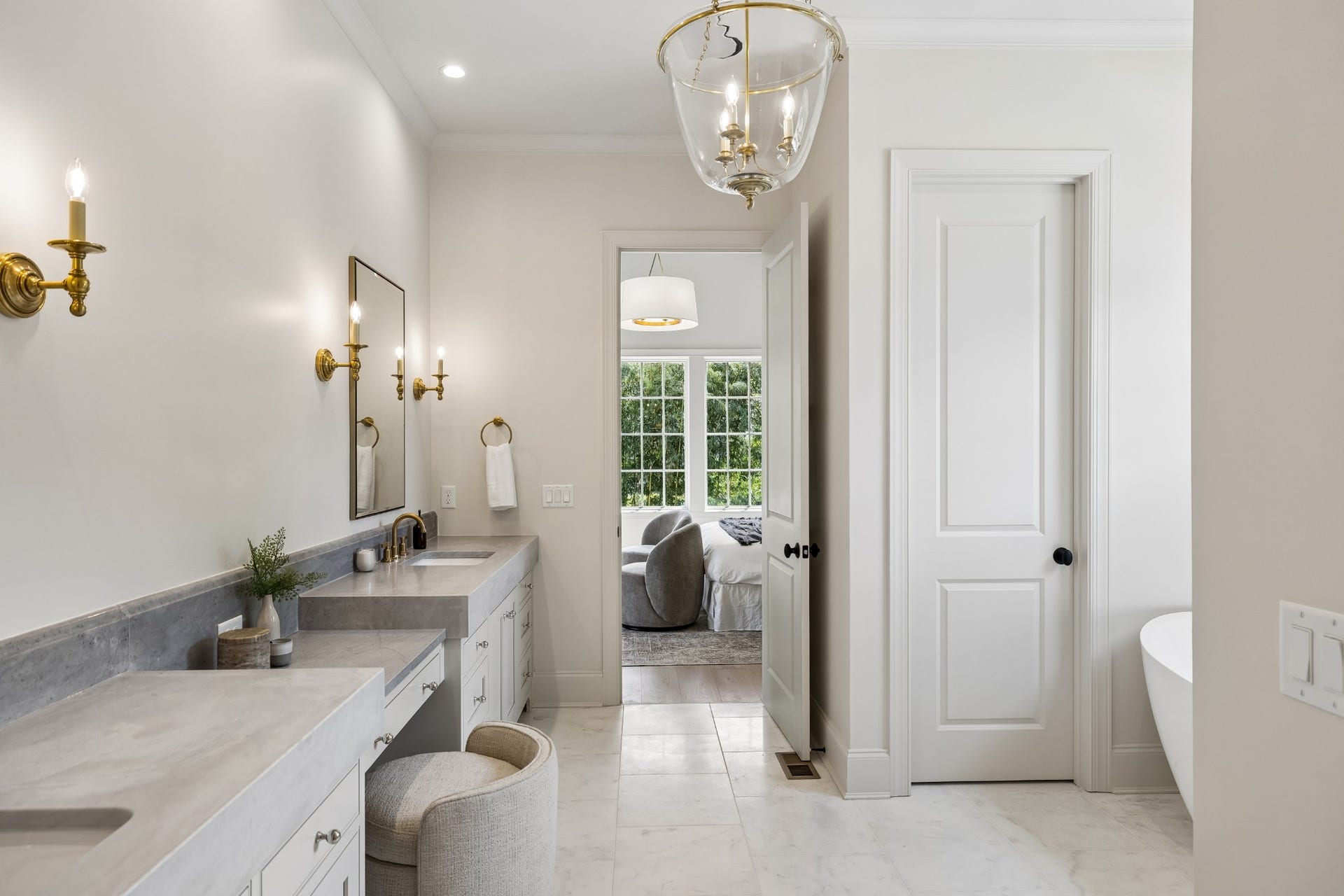 1133 Maplehurst Ln, Nashville, TN 37204 Thoughtfully designed primary bath offers expansive vanity space, designer lighting, beautiful stone surfaces, and direct access between the bath and primary suite.