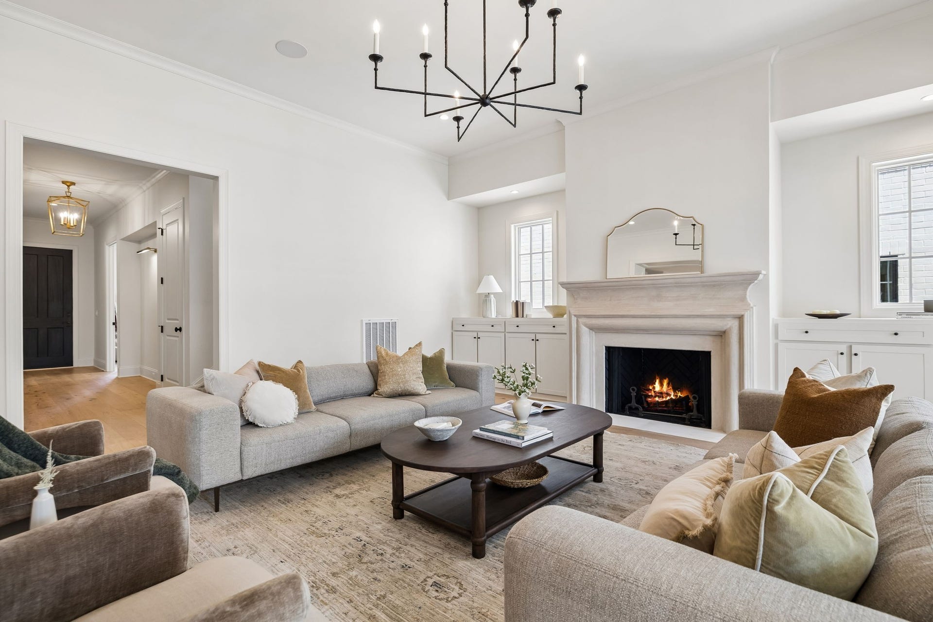 1133 Maplehurst Ln, Nashville, TN 37204 The fireplace creates an inviting focal point, complemented by symmetrical built-in cabinetry, tall windows, and sophisticated architectural details.