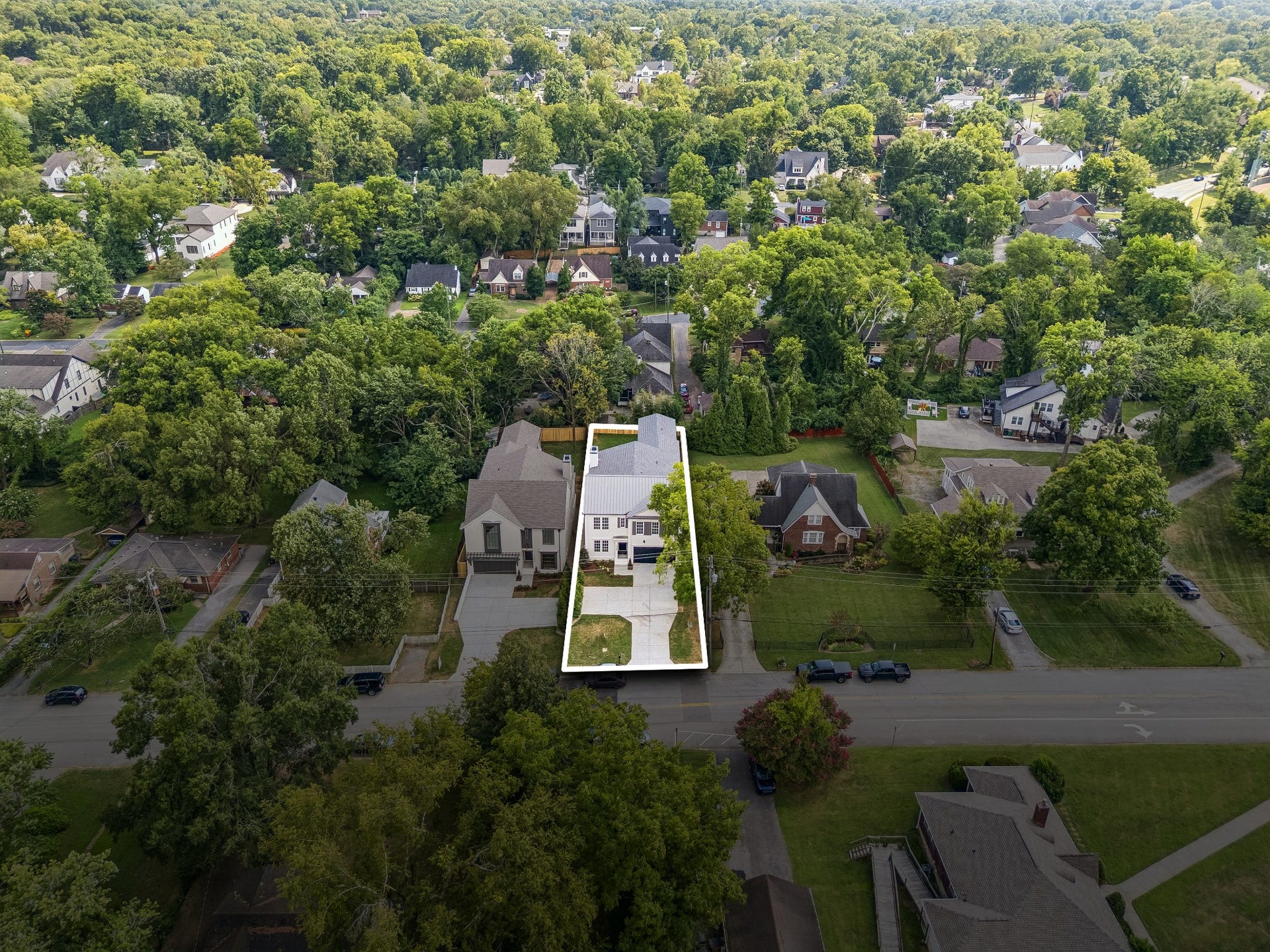 1133 Maplehurst Ln, Nashville, TN 37204 Aerial view showcases the unusually wide HPR lot, generous extra parking pad, and 8-foot privacy trees thoughtfully separating the neighboring parking areasproviding exceptional space and privacy for city living.