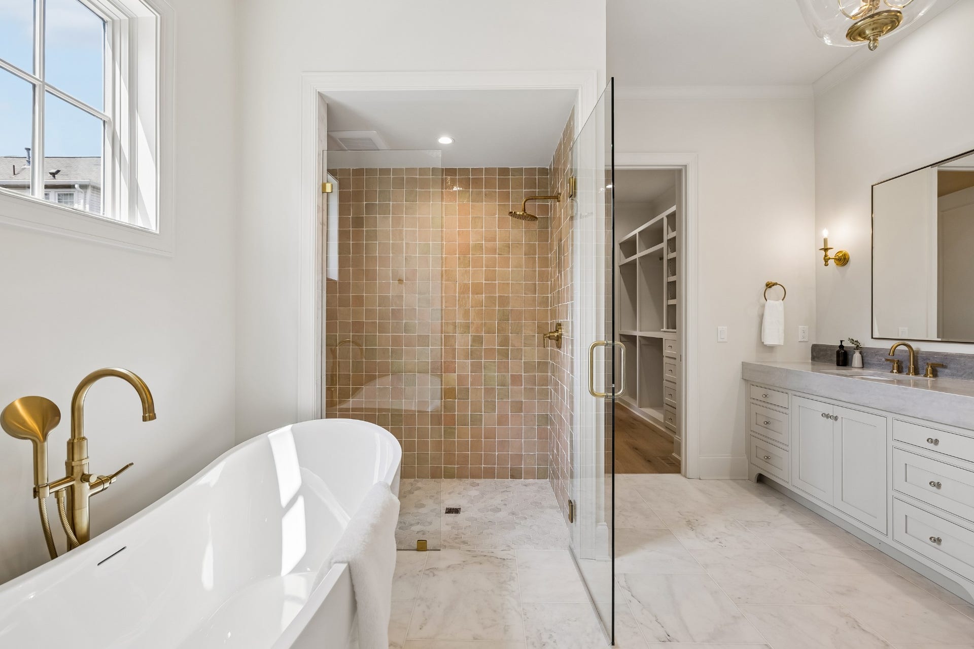 1133 Maplehurst Ln, Nashville, TN 37204 The luxurious primary bath continues with a freestanding soaking tub and spacious walk-in shower featuring floor-to-ceiling tile, built-in bench, and glass enclosure