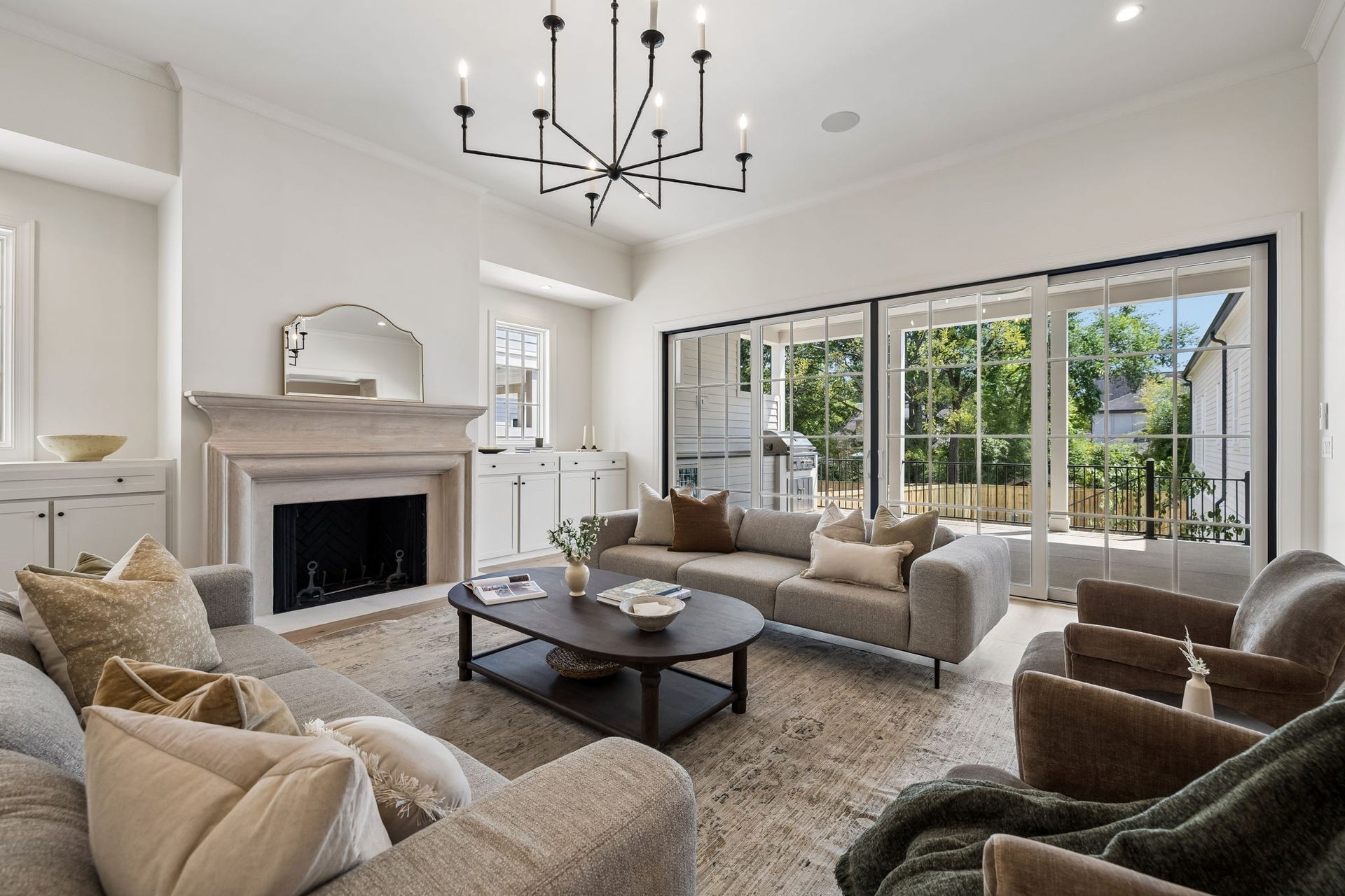 1133 Maplehurst Ln, Nashville, TN 37204 Expansive glass doors fill the great room with natural light and create a seamless connection to the covered outdoor living area.