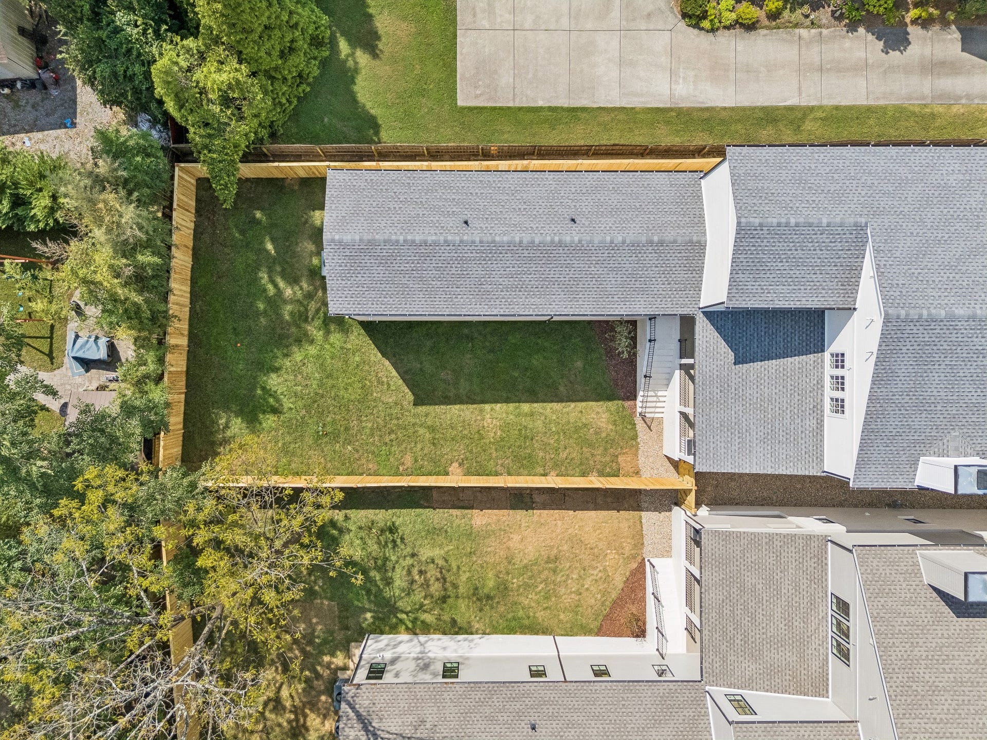 1133 Maplehurst Ln, Nashville, TN 37204 Aerial view highlights the unusually wide HPR lot, large fully fenced backyard, covered outdoor living area, and impressive privacyvaluable outdoor space rarely found with newer luxury construction.
