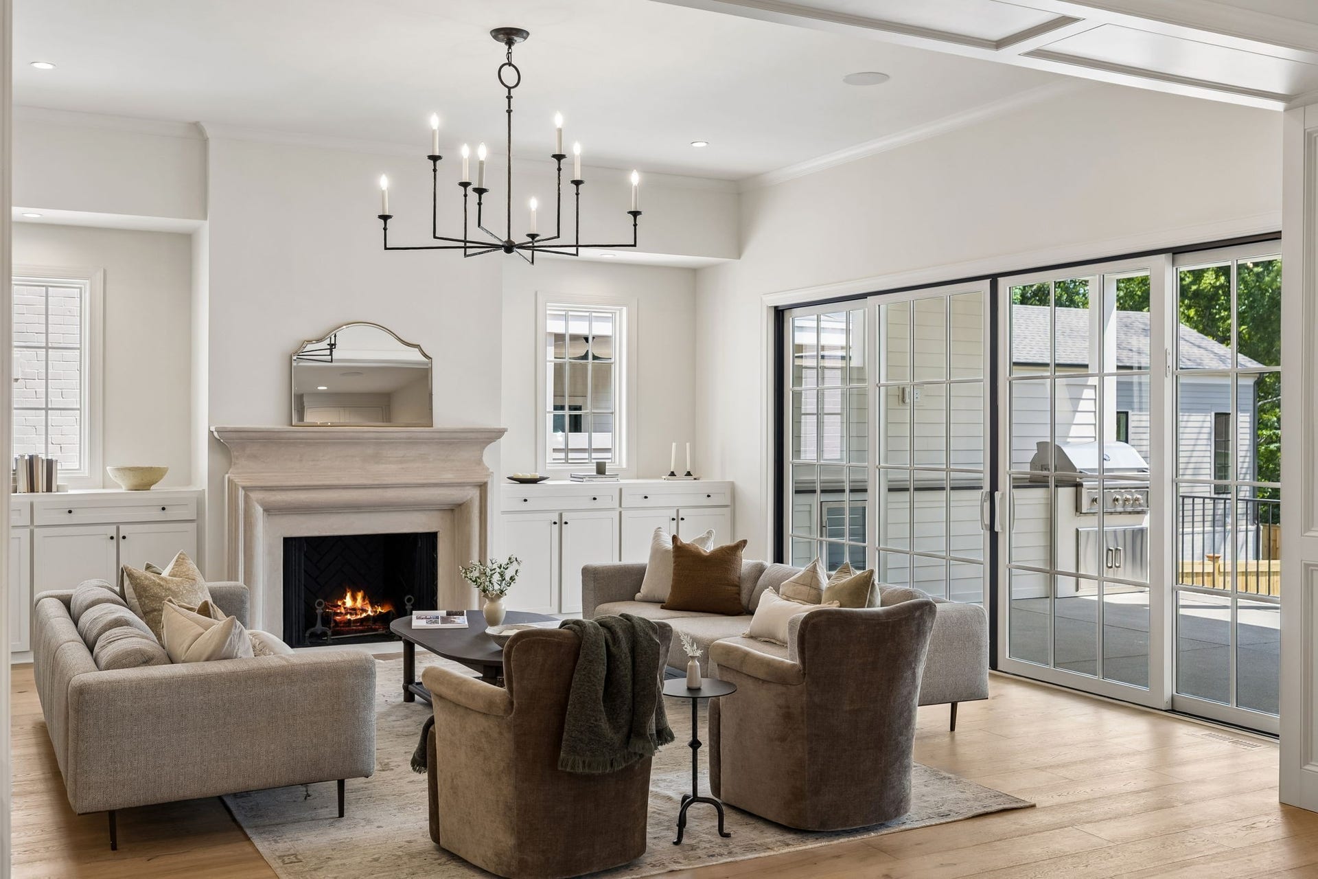 1133 Maplehurst Ln, Nashville, TN 37204 Classic fireplace detailing and custom cabinetry bring warmth and character to the great room while maintaining the homes clean, sophisticated design. (fire is AI)