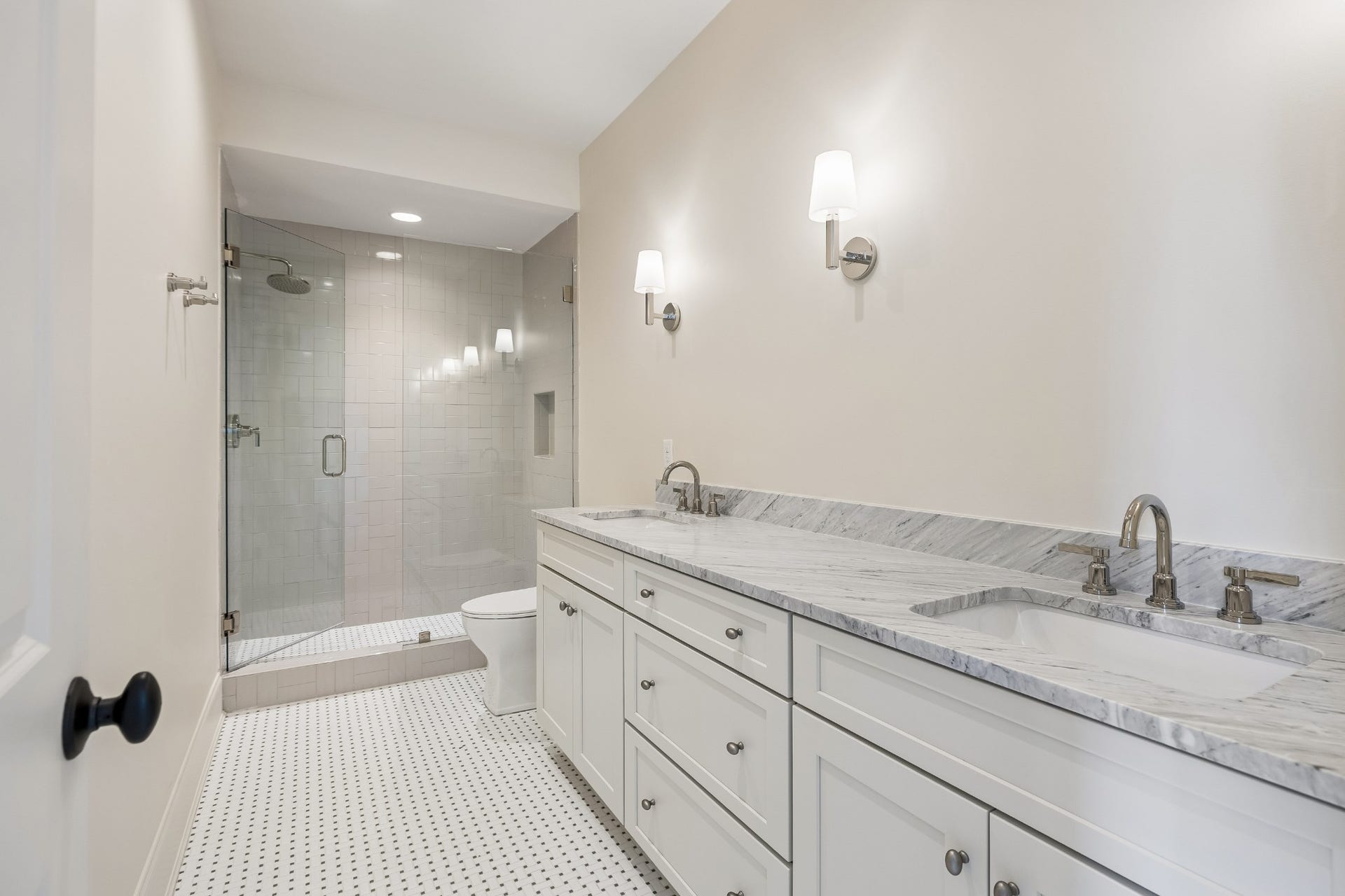 1133 Maplehurst Ln, Nashville, TN 37204 Tucked away down its own hallway, Bedroom 5 offers exceptional privacyideal for guests, older children, or extended stays. The spacious suite includes a private full bath with double vanity and glass-enclosed shower, plus a large custom walk-in clos