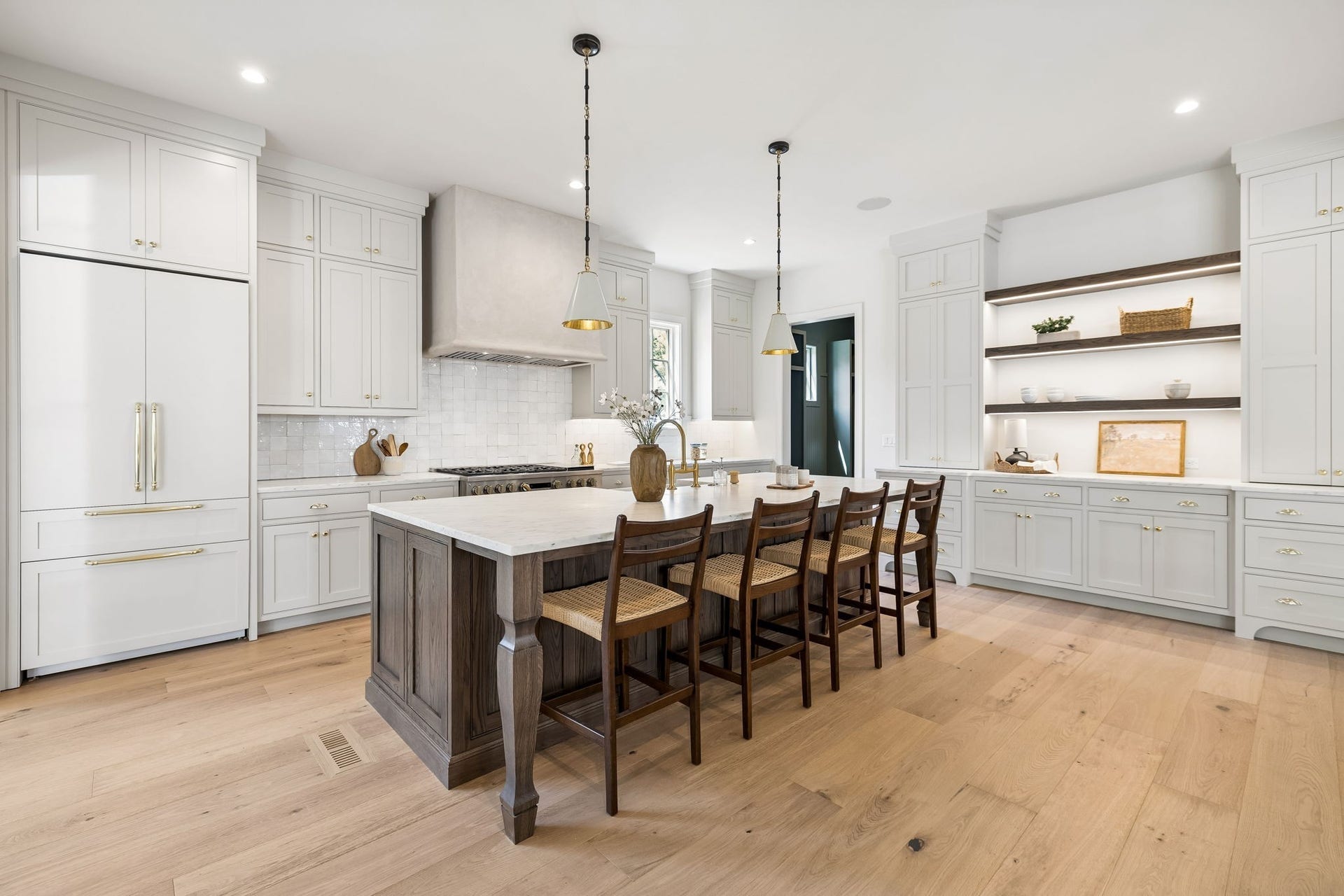 1133 Maplehurst Ln, Nashville, TN 37204 Showpiece kitchen centers around an oversized contrasting island with generous seating, surrounded by extensive custom cabinetry, designer lighting, and beautiful hardwood floors.