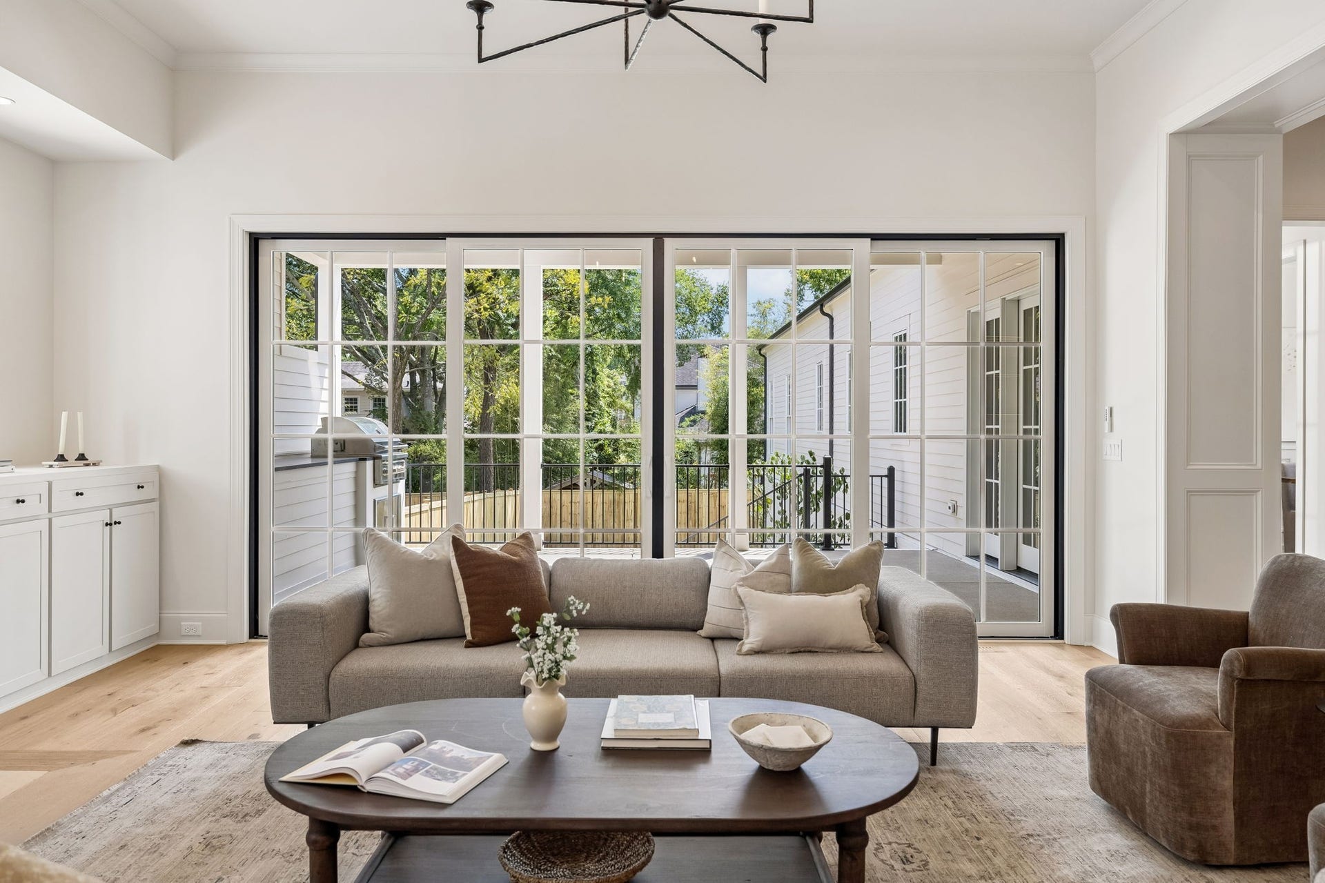 1133 Maplehurst Ln, Nashville, TN 37204 Walls of glass visually expand the great room and showcase the covered porch beyond, creating a bright, airy space designed for both entertaining and everyday living.
