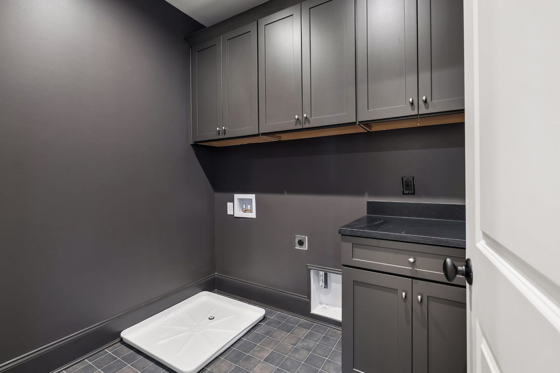 1133 Maplehurst Ln, Nashville, TN 37204 Dedicated 2nd floor laundry room features extensive cabinetry, countertop workspace, utility sink, and abundant storage for a functional yet polished everyday space