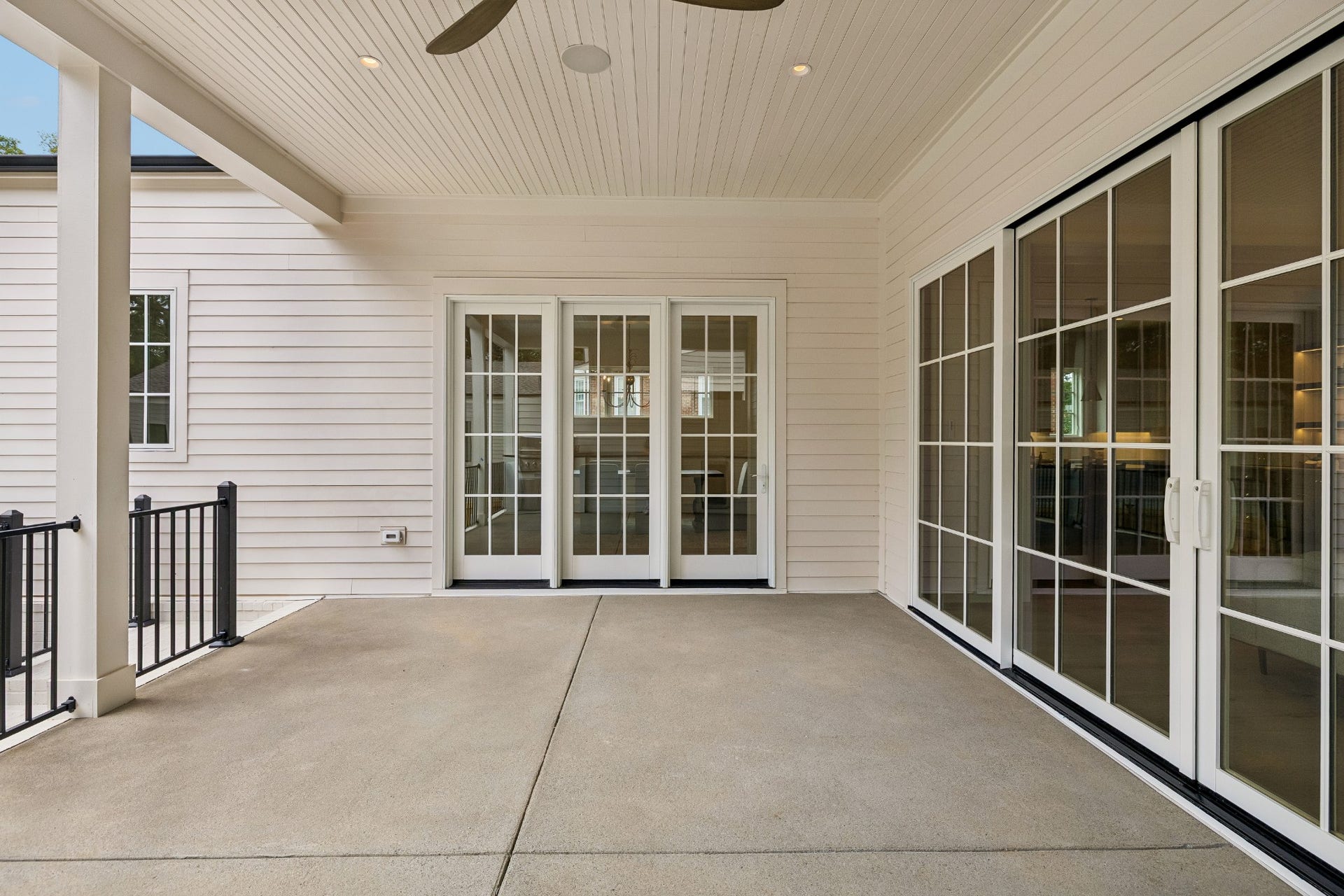 1133 Maplehurst Ln, Nashville, TN 37204 Expansive covered outdoor living area creates a true extension of the home, with a beadboard ceiling, recessed lighting, ceiling fan, and oversized glass doors connecting directly to the interior living spaces.