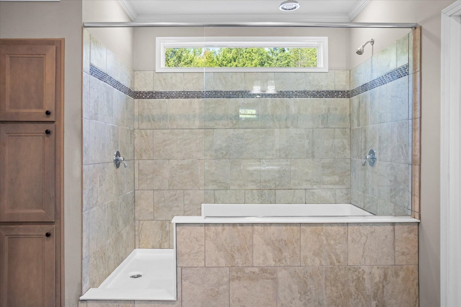 Primary bath has extra cabinetry and a super shower
