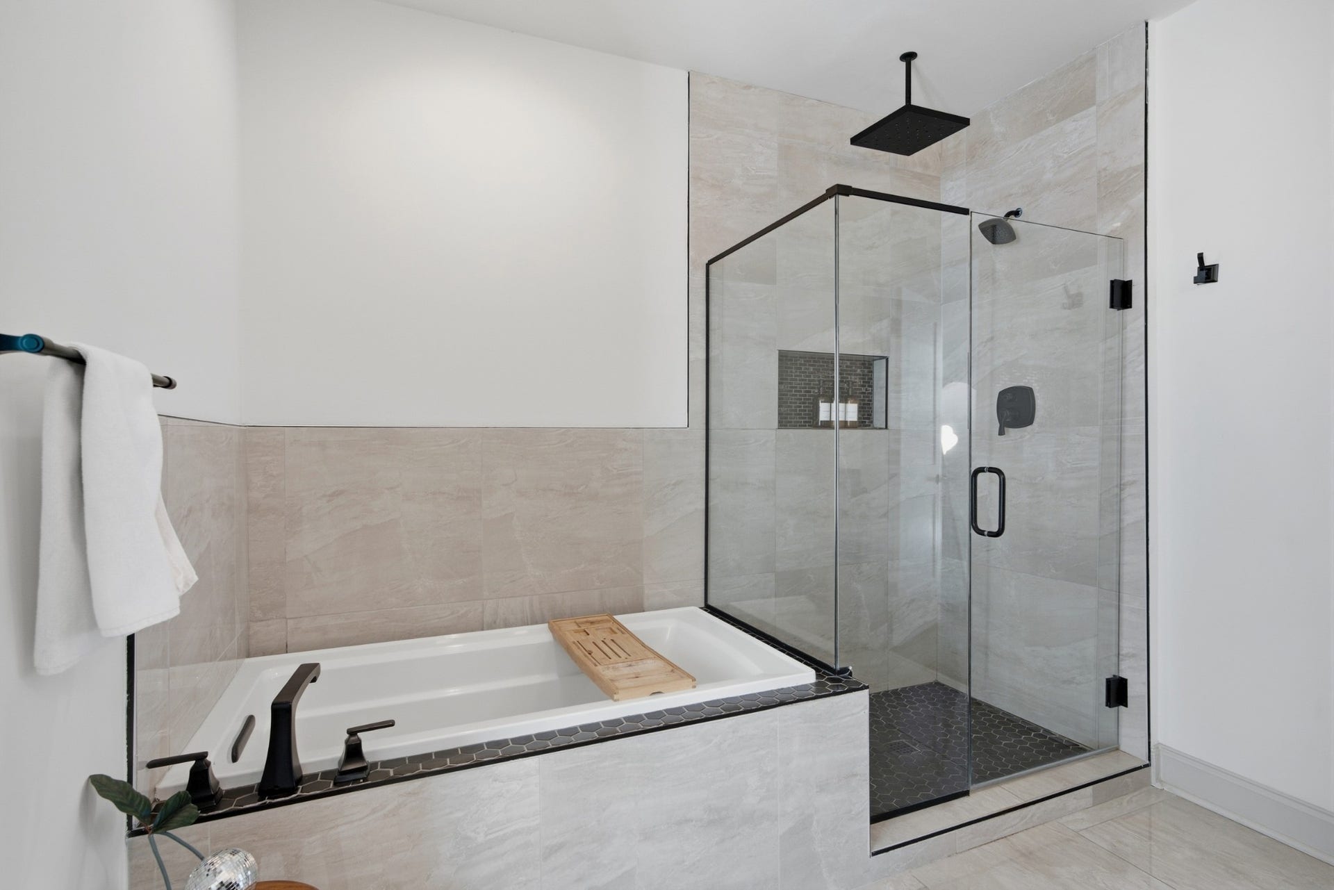 Choose between the rainfall shower or a long soak in the oversized tub for an elevated everyday escape.