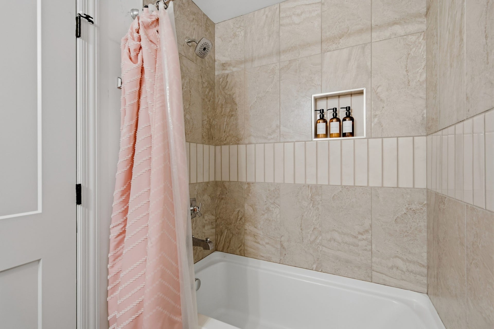 A custom-tiled tub and shower combination adds both style and practicality to the space.