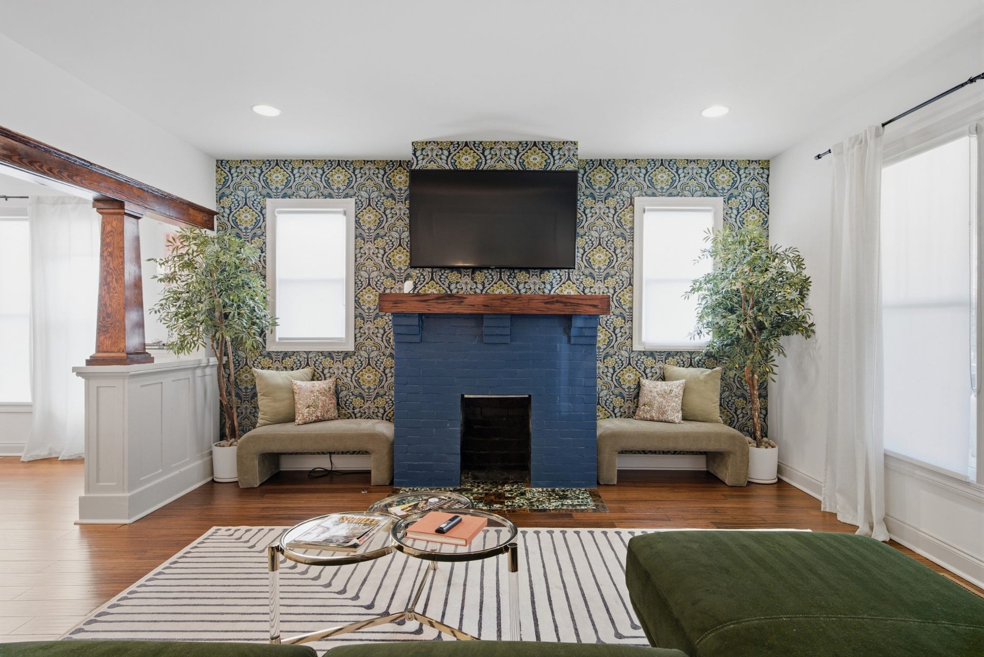 Statement wallpaper brings instant character to the spacious living room.