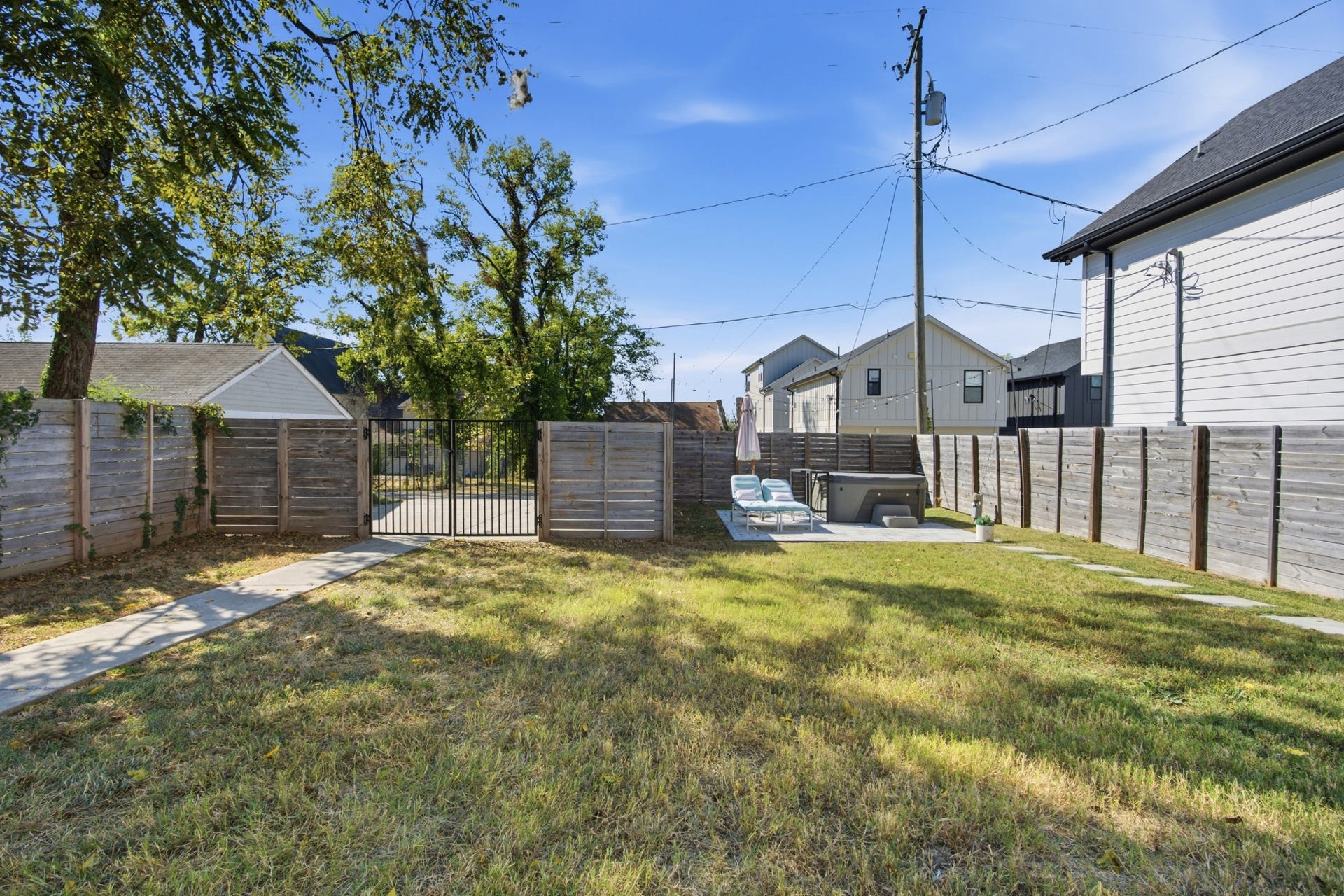 Beyond the deck, the fully fenced backyard offers generous green space ready for pets, play, gardening, and more.
