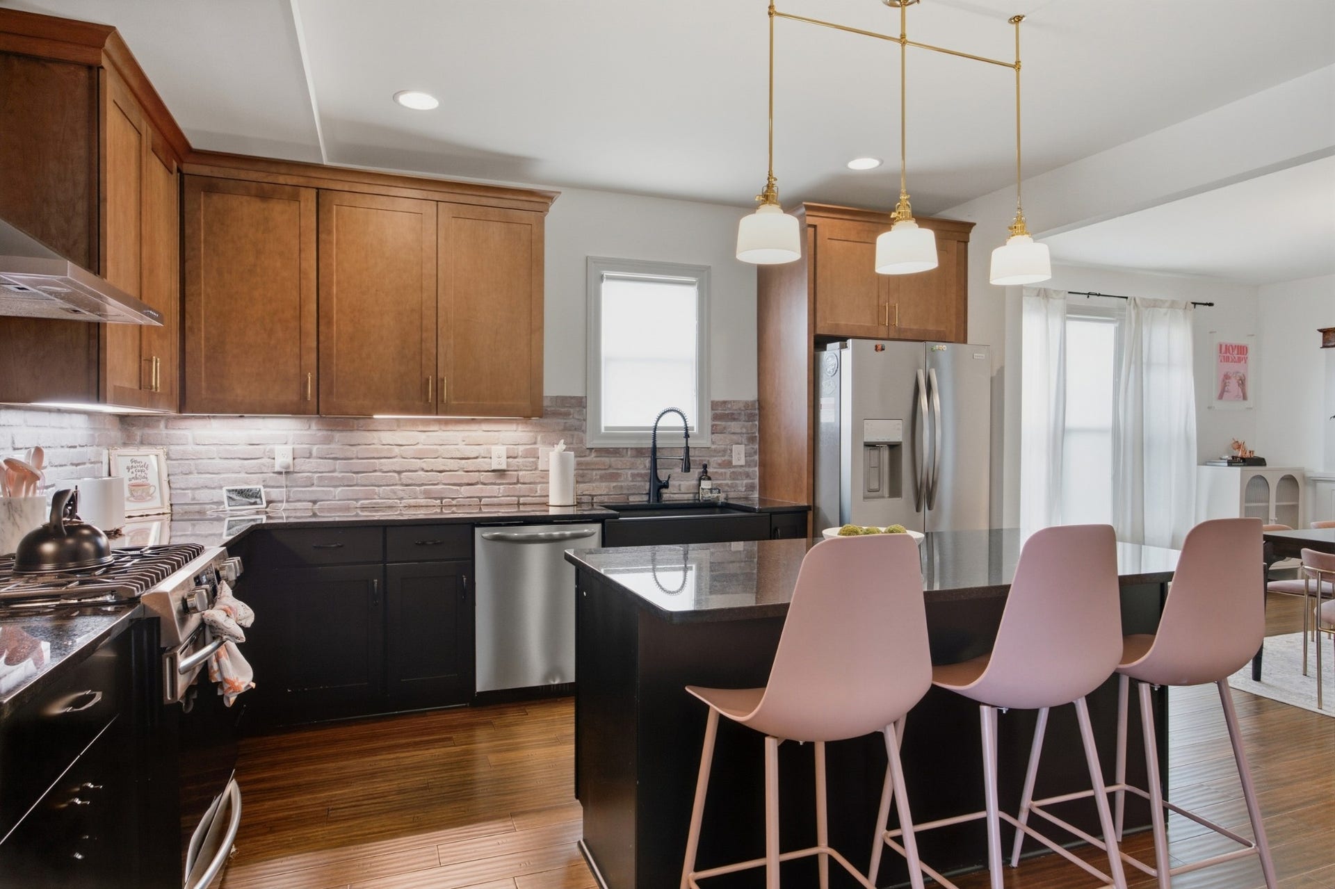 The kitchen makes an elevated statement with an oversized island serving as its centerpiece.