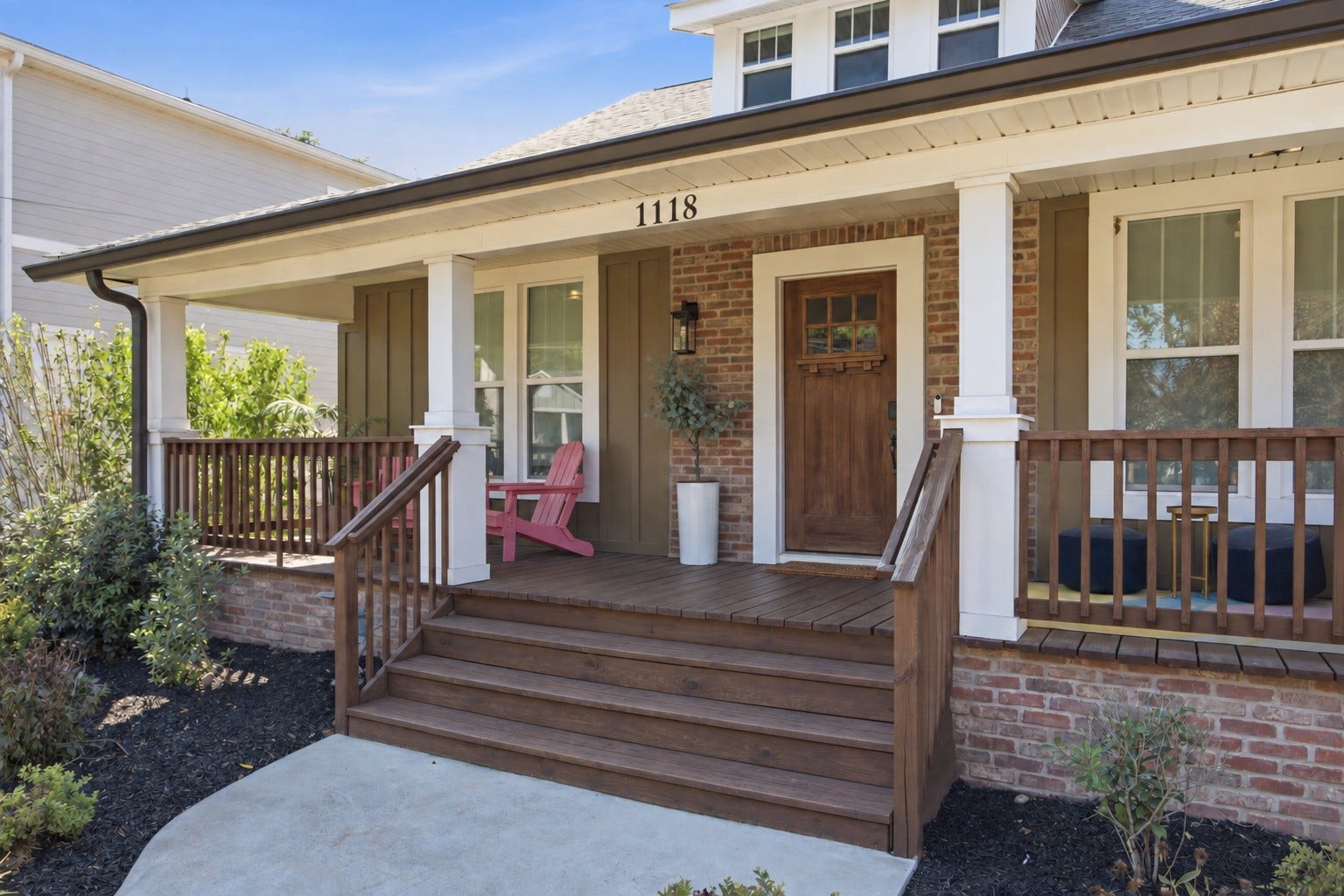 Timeless curb appeal makes a memorable first impression, complemented by attractive landscaping and a welcoming covered front porch.