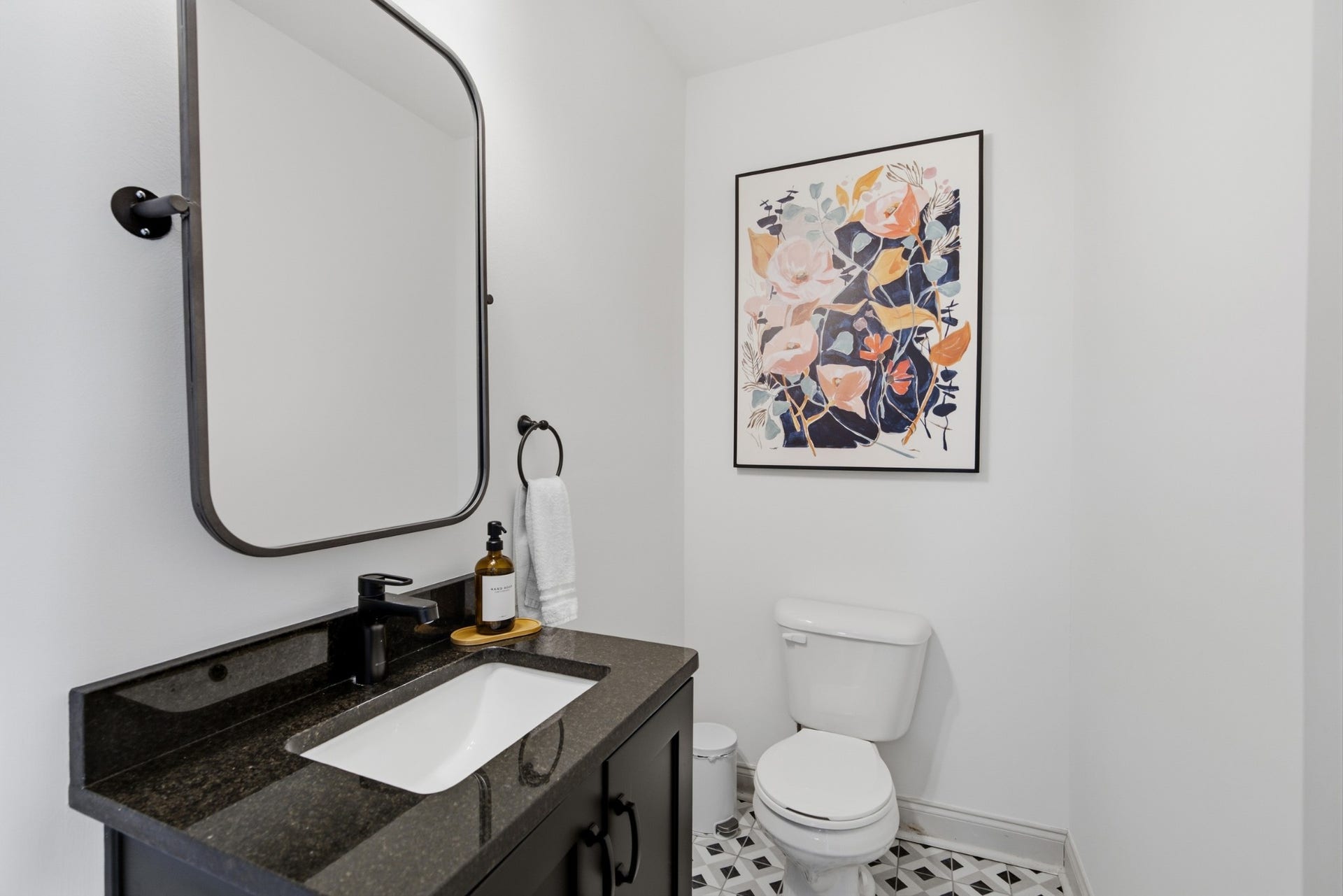 A convenient main-level powder room adds ease for residents and guests alike.