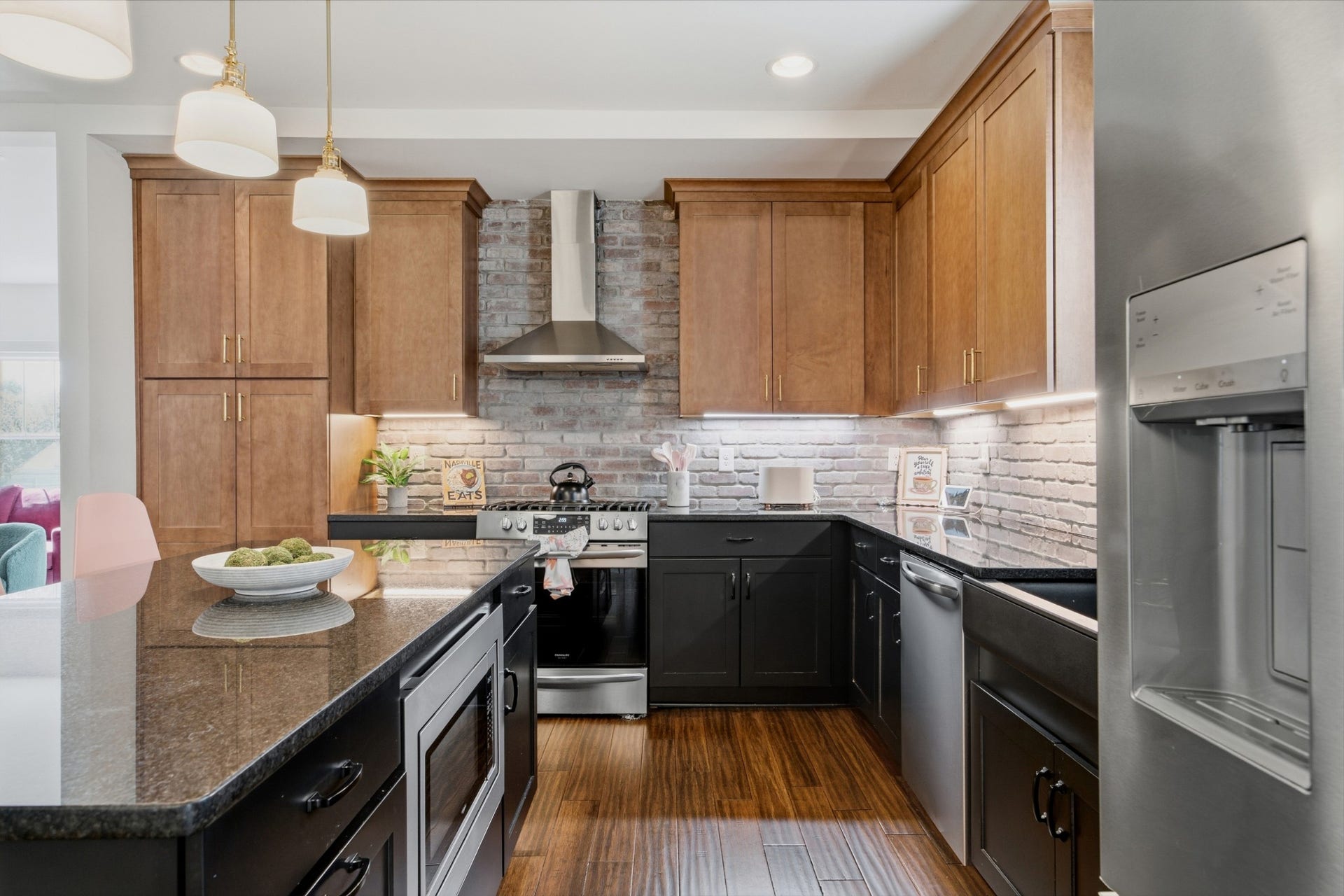 Sleek hardware and stainless steel appliances bring a polished edge to the kitchen's design.