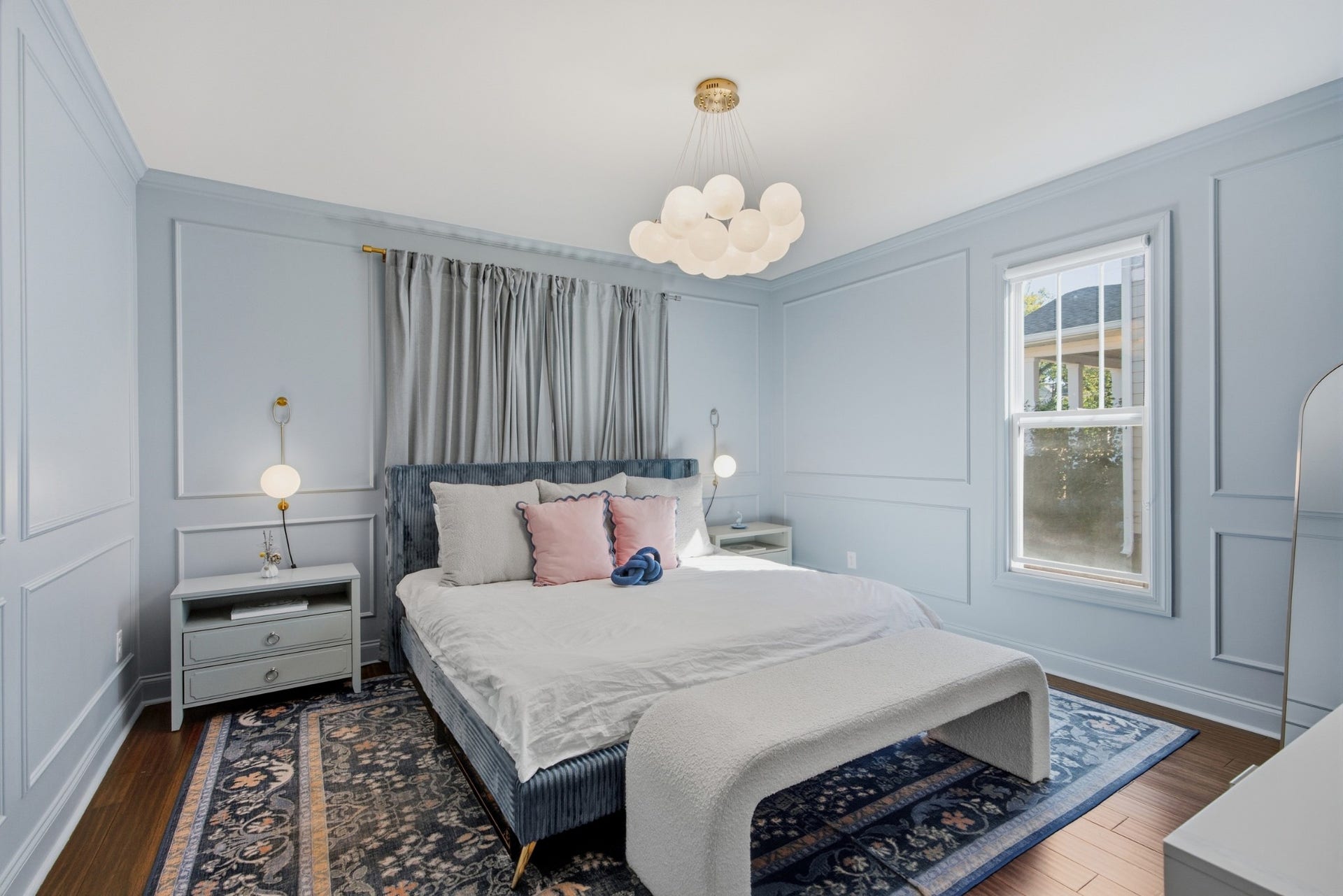 The spacious main-level primary suite feels like a private retreat, elevated by custom millwork.