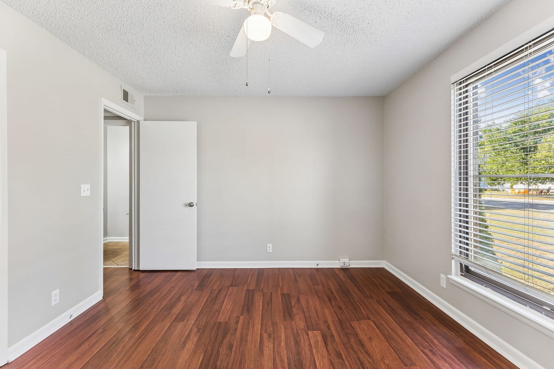 This home boasts two oversized bedrooms.  This one is on the front of the house with great natural light from the window.  Note the blinds that are already installed!