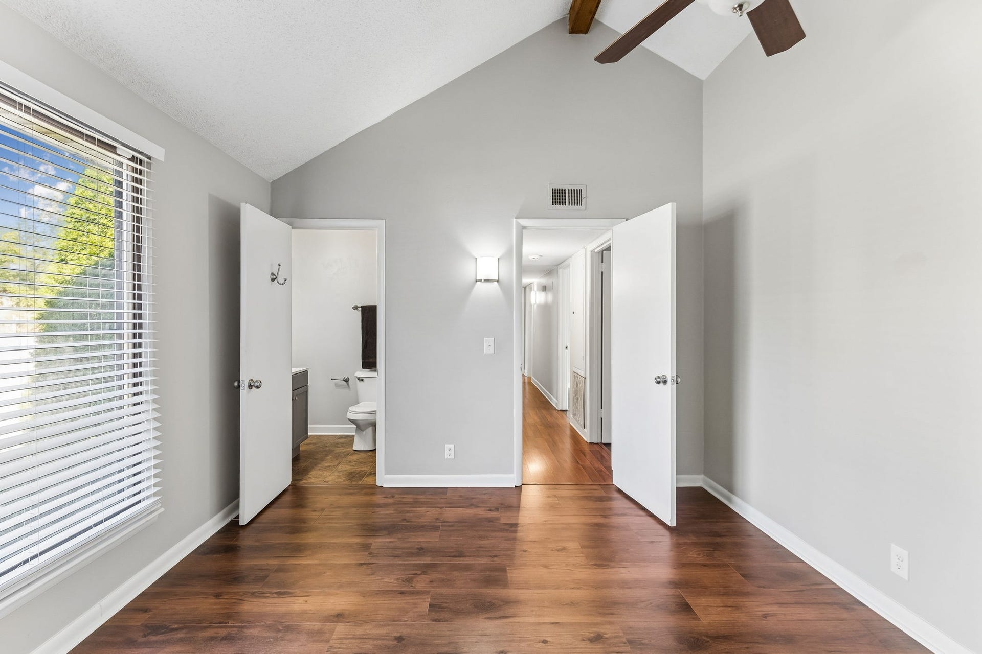 The beamed, vaulted ceiling of the owner's suite has remote controlled ceiling fan.