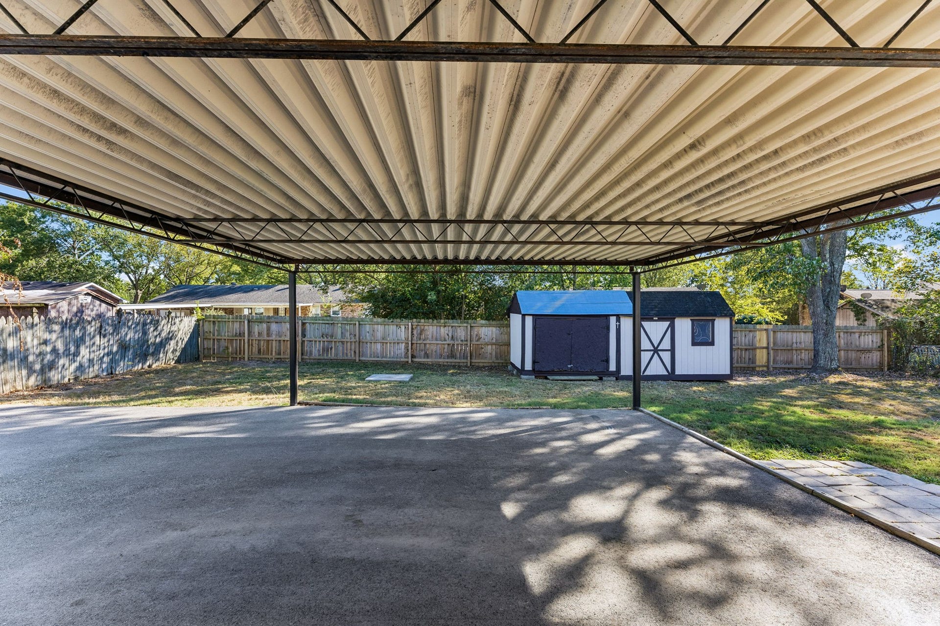 The two car carport is attached and offers great protection for the cars.  Look!  Two exterior storage buildings.