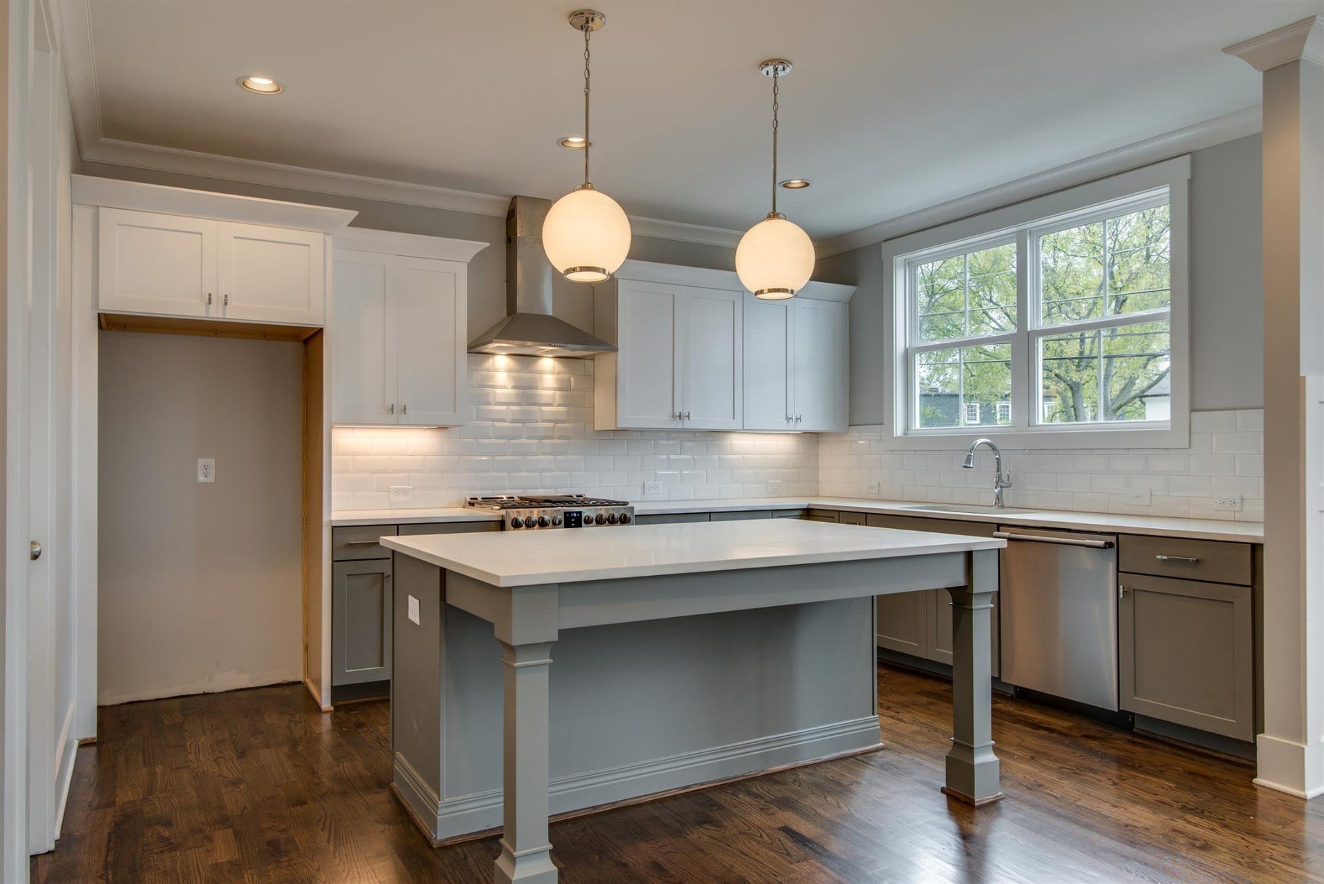 1711 10th Avenue S, Nashville, TN 37203 Kitchen with designer lighting, lots of windows, under mount lights, stainless appliances.