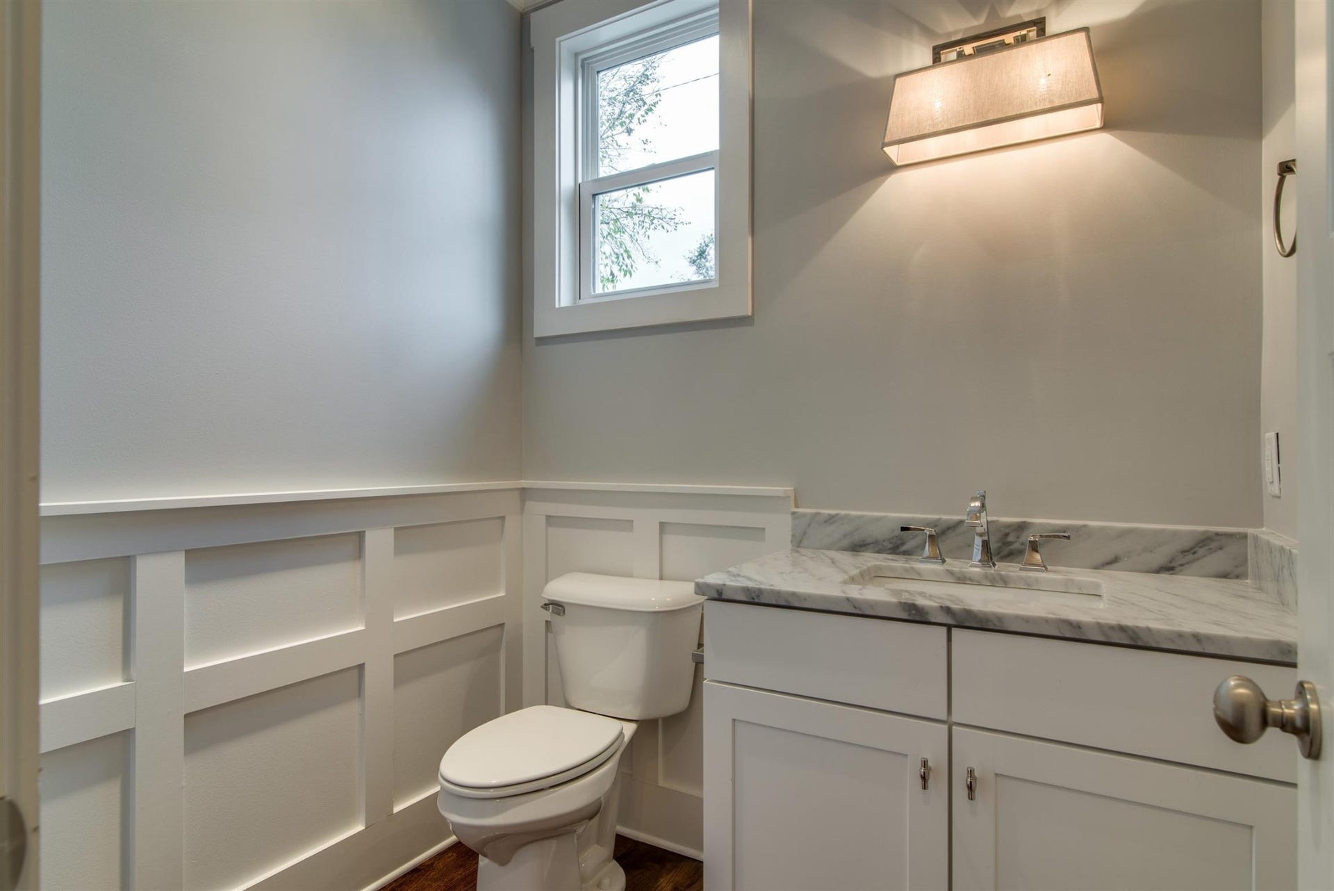 1711 10th Avenue S, Nashville, TN 37203 Half bathroom with marble counter top, hardwood floors.
