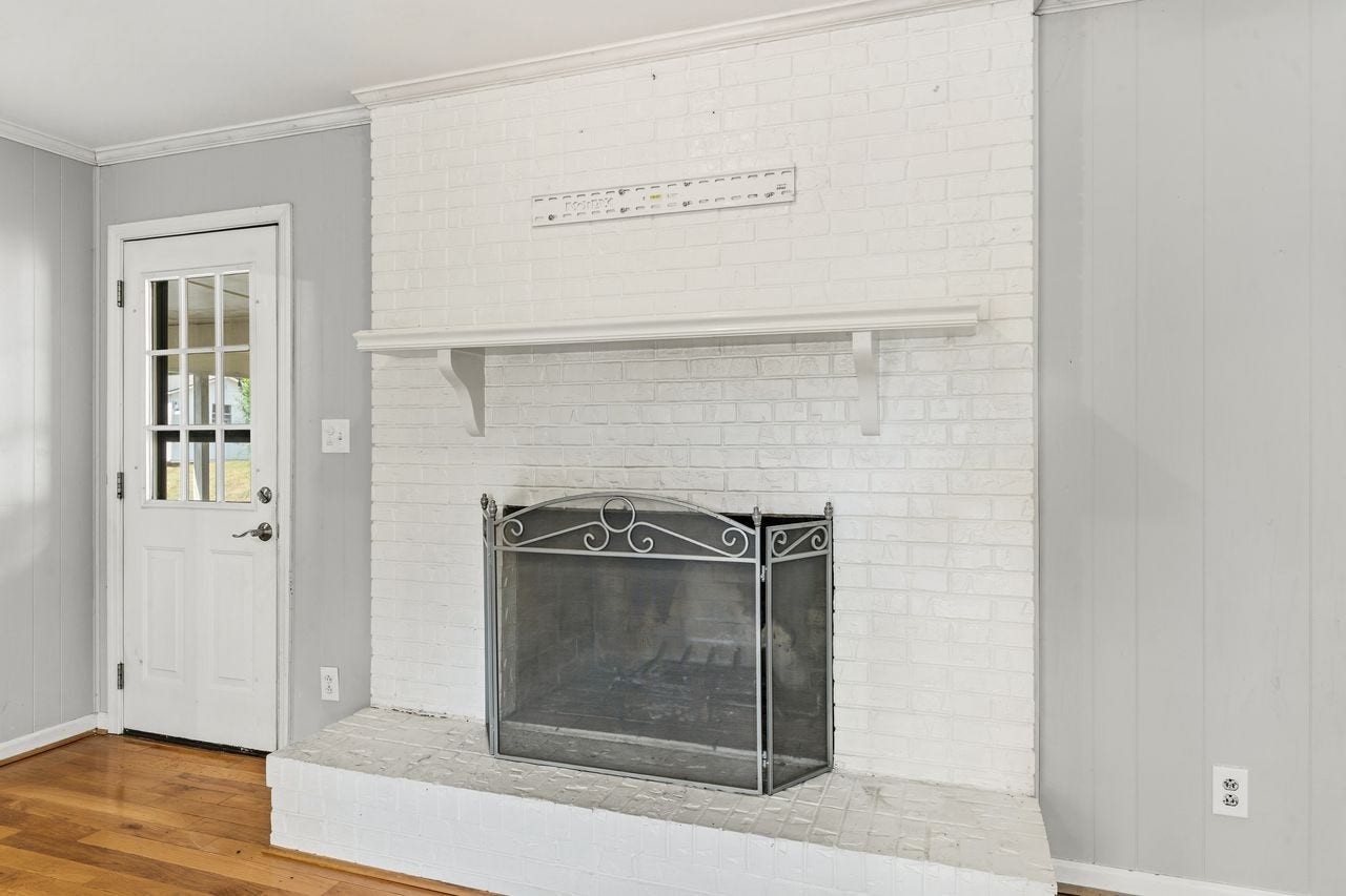 1408 Lyon St, Columbia, TN 38401 Painted brick fireplace in den