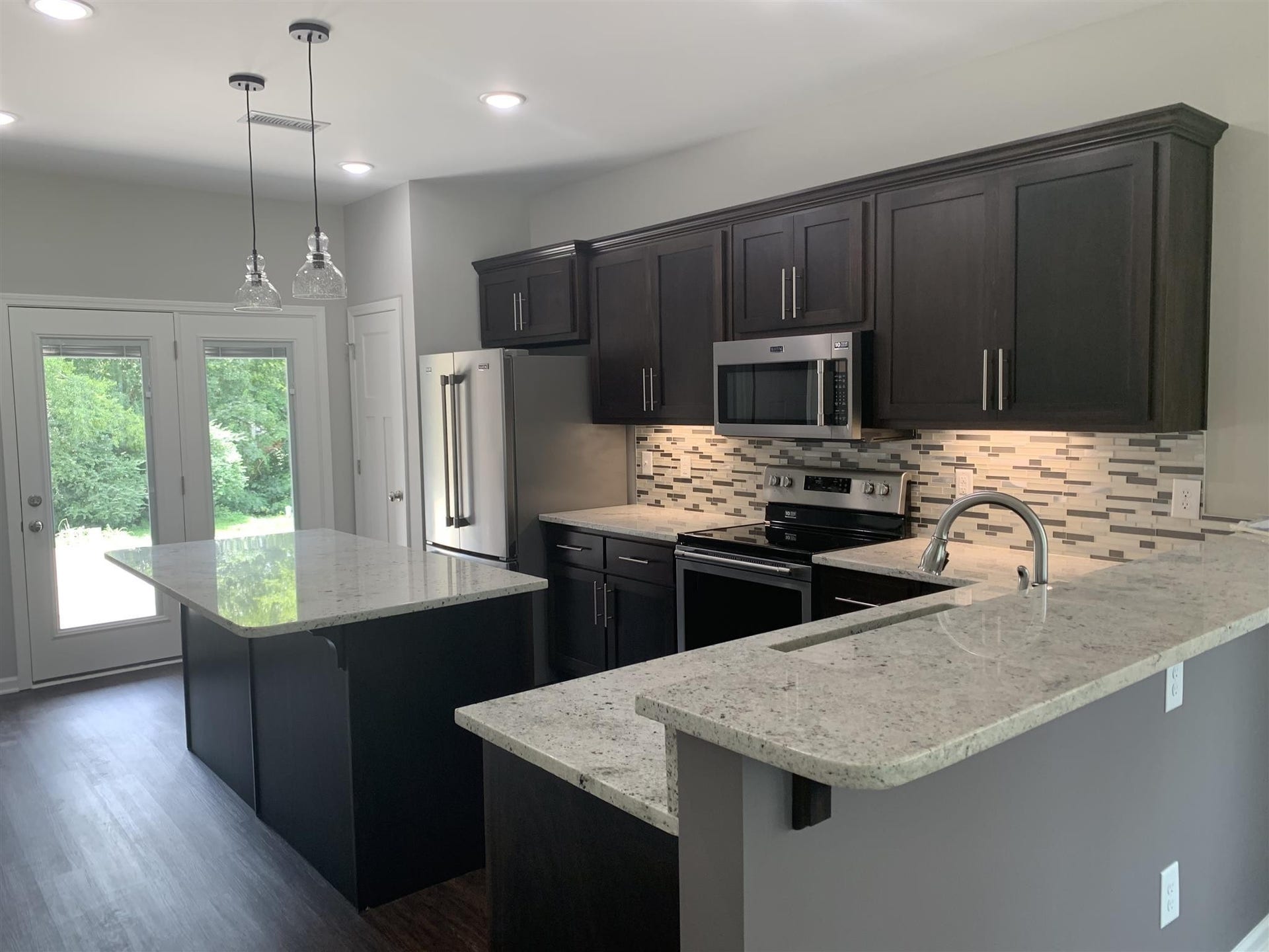Large kitchen with island and raised bar. S/S appliances