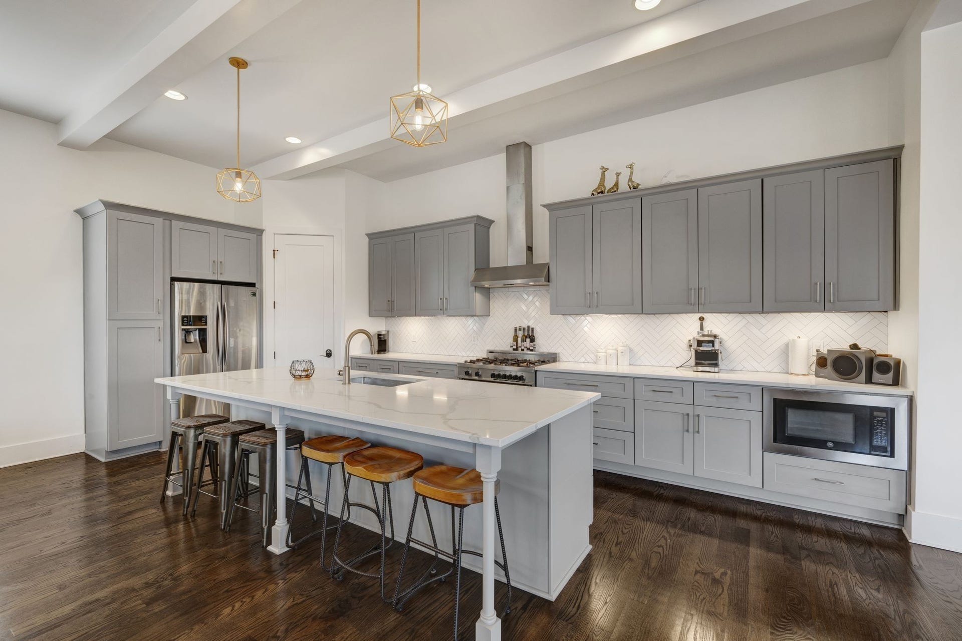 Bring your cooking skills and break bread on this oversized quartz island with room for 6 for  casual dining.