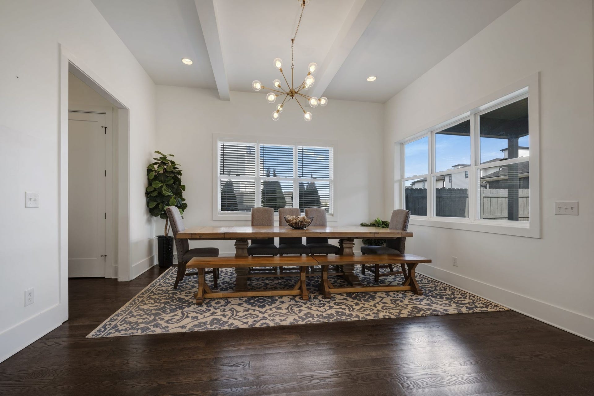 The dining room is set apart, offering ample space to comfortably seat 12perfect for hosting your next special occasion meal or everyday dining. The garage entrance is to the left with a drop zone for coats/shoes/backpacks.