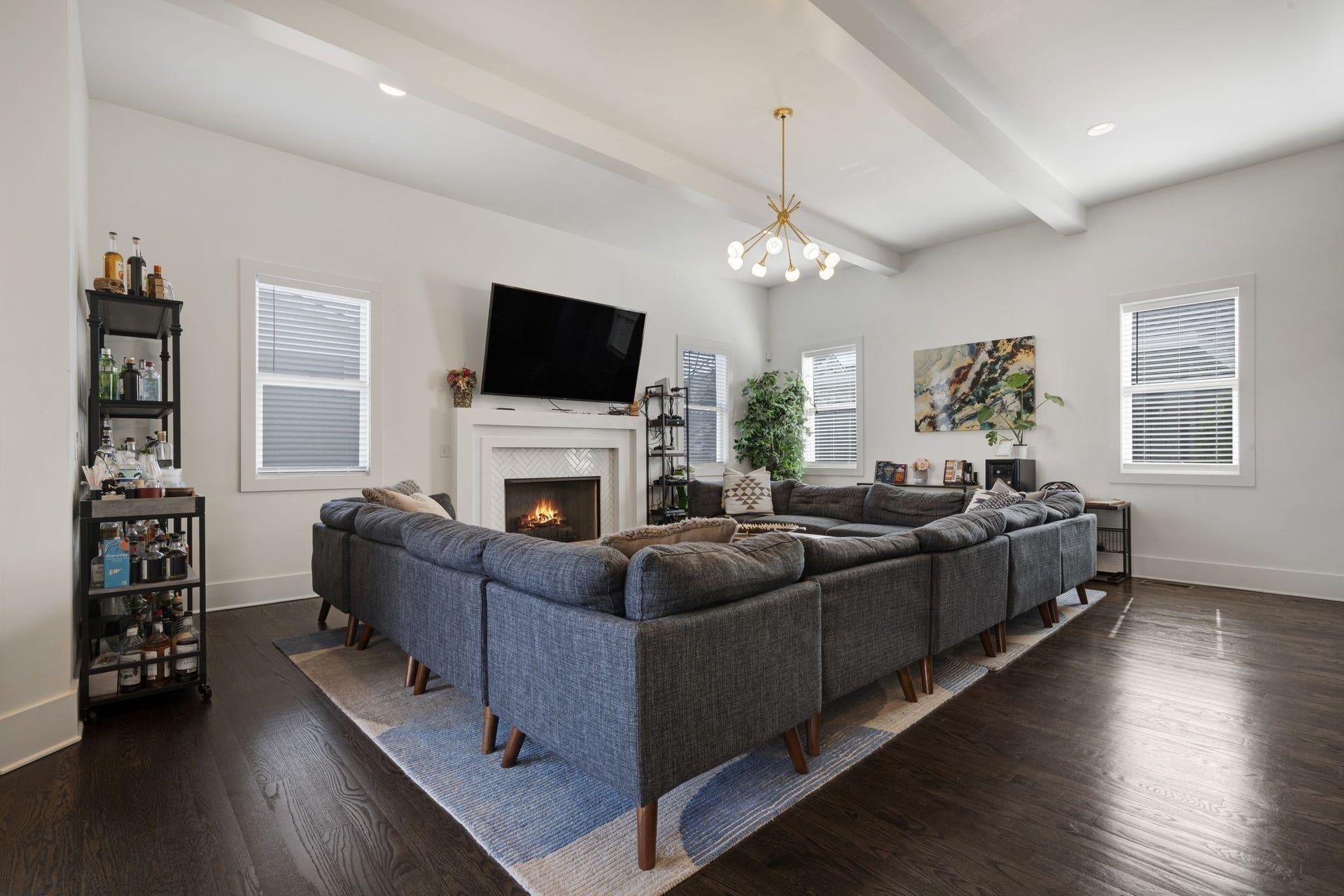 This living room can accommodate a massive sectional (avail for sale) anchord by the tiled gas fireplace and exposed ceiling beams for approachable drama.