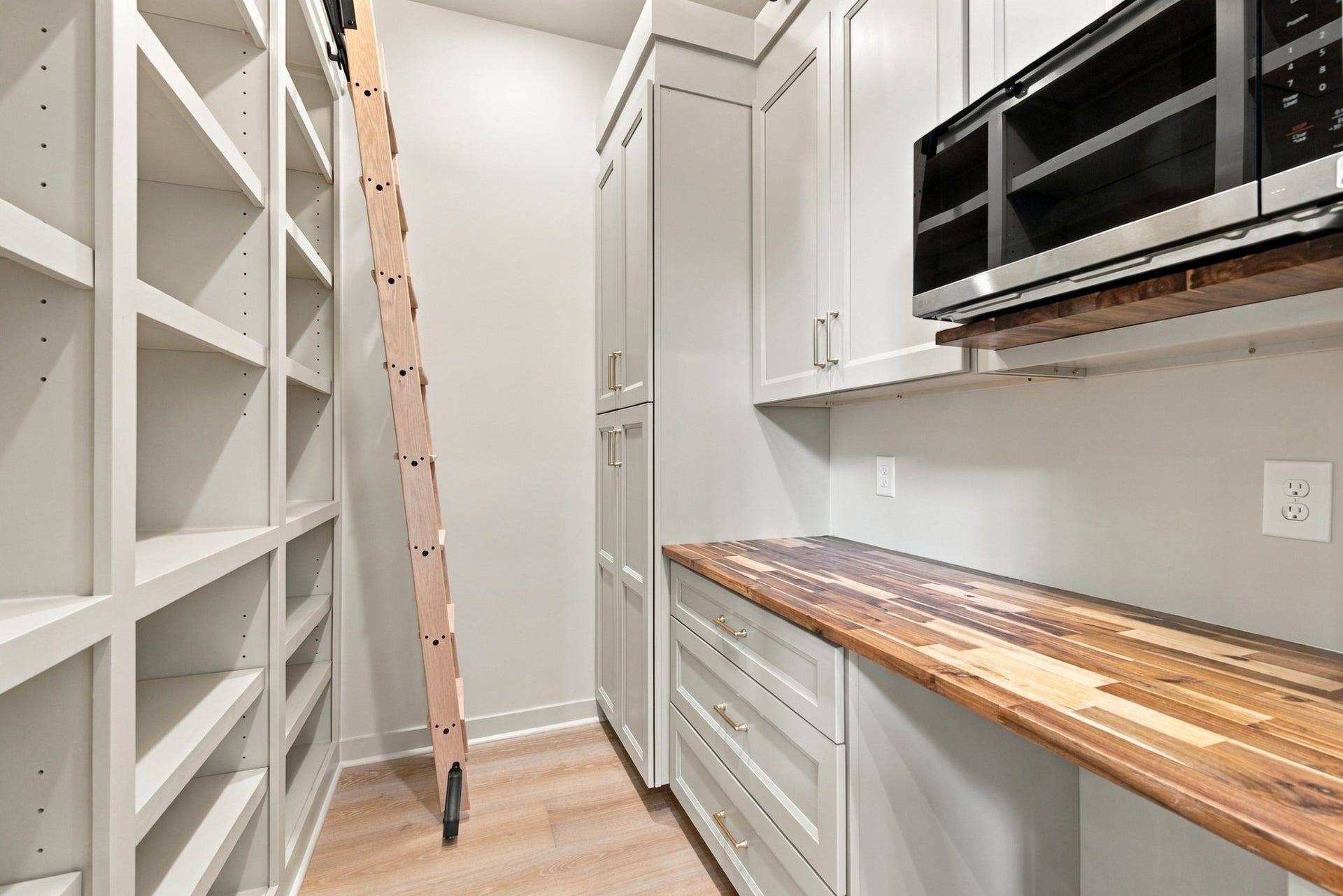 1001 Wright Branch Ct, Mount Juliet, TN 37122 This home makes it easy for a big family to stay organzied and accessible in this pantry. The ladder can be moved from one side to the other for seaasonal items and the shelves are adjustable. The butcher block countertop just brings it all together