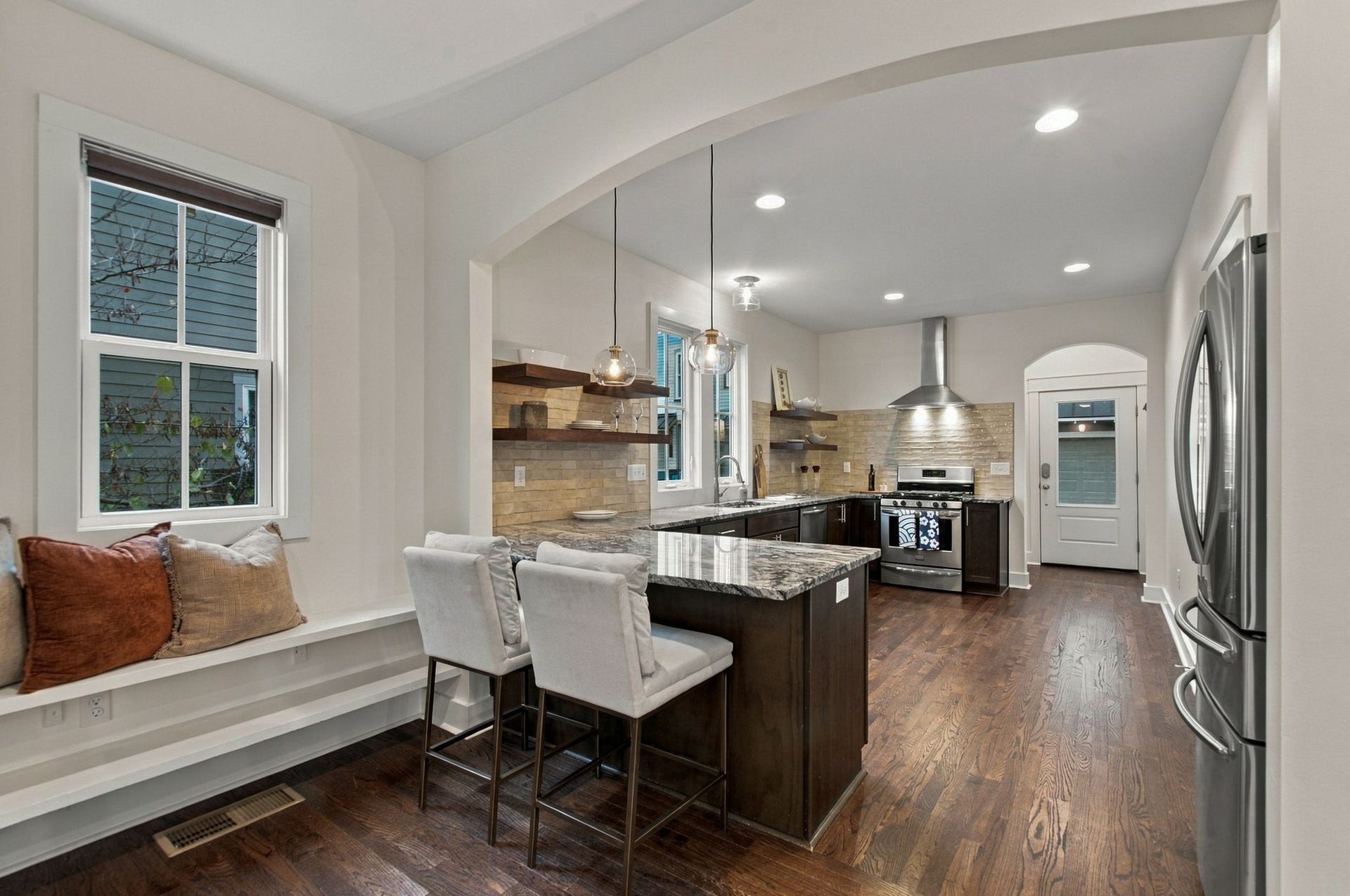 The kitchen has a peninsula for food prep, serving and seating for two