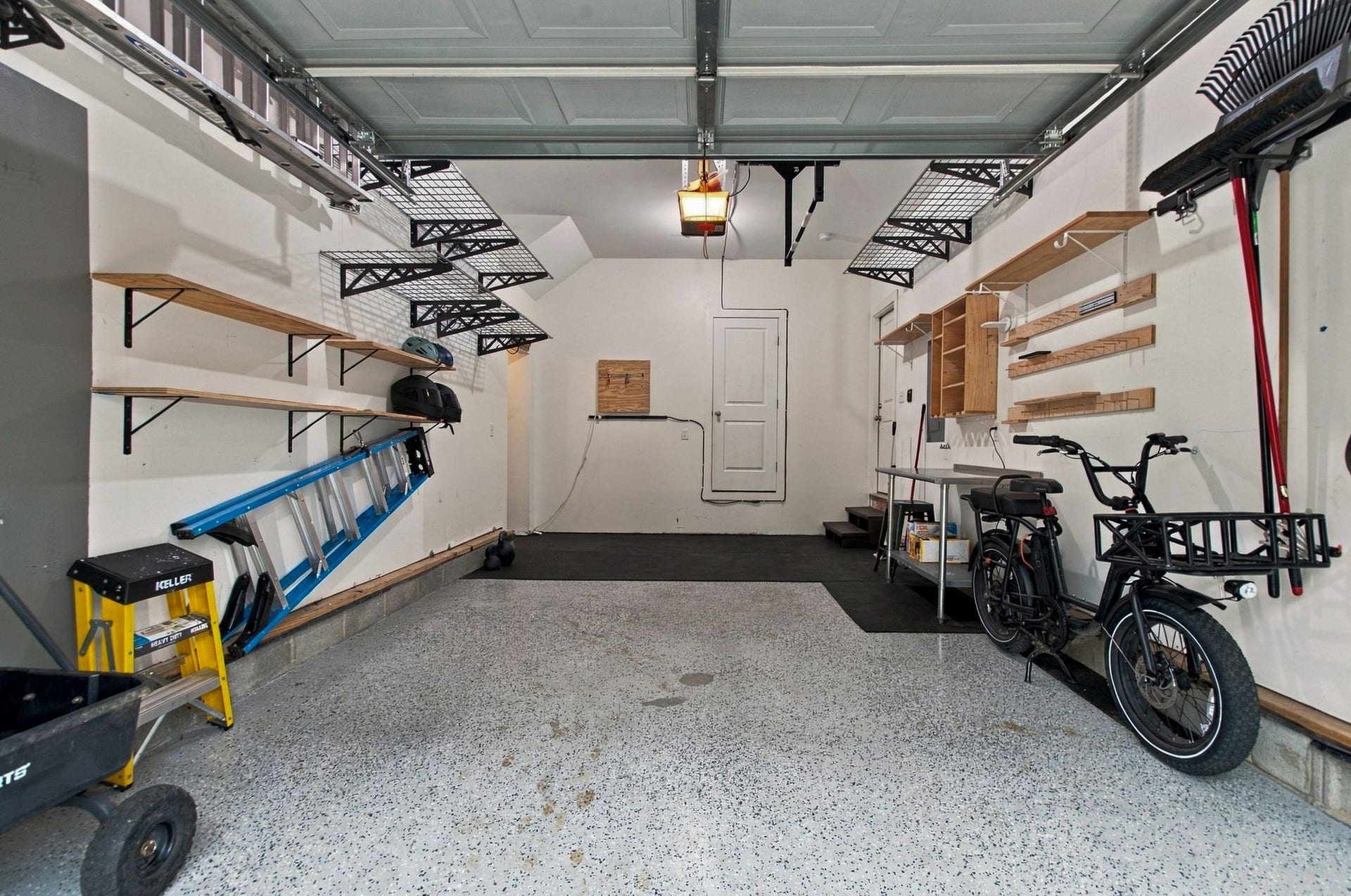 The garage is decked for storage and has additional storage space behind the door that you see at the end and through the opening in the right end corner