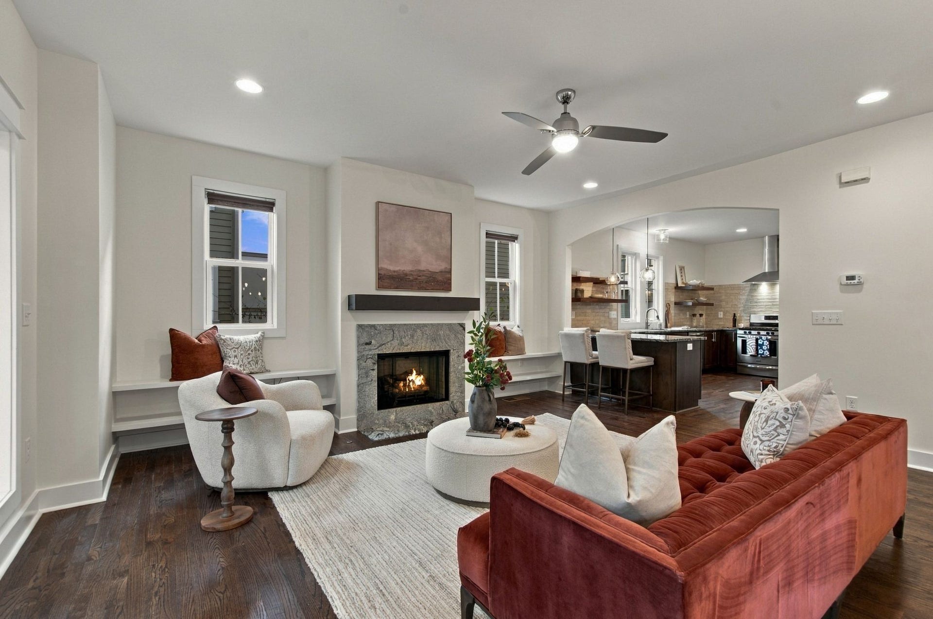 Another view of the living room showcasing the lovely arched opening from the living room to the kitchen