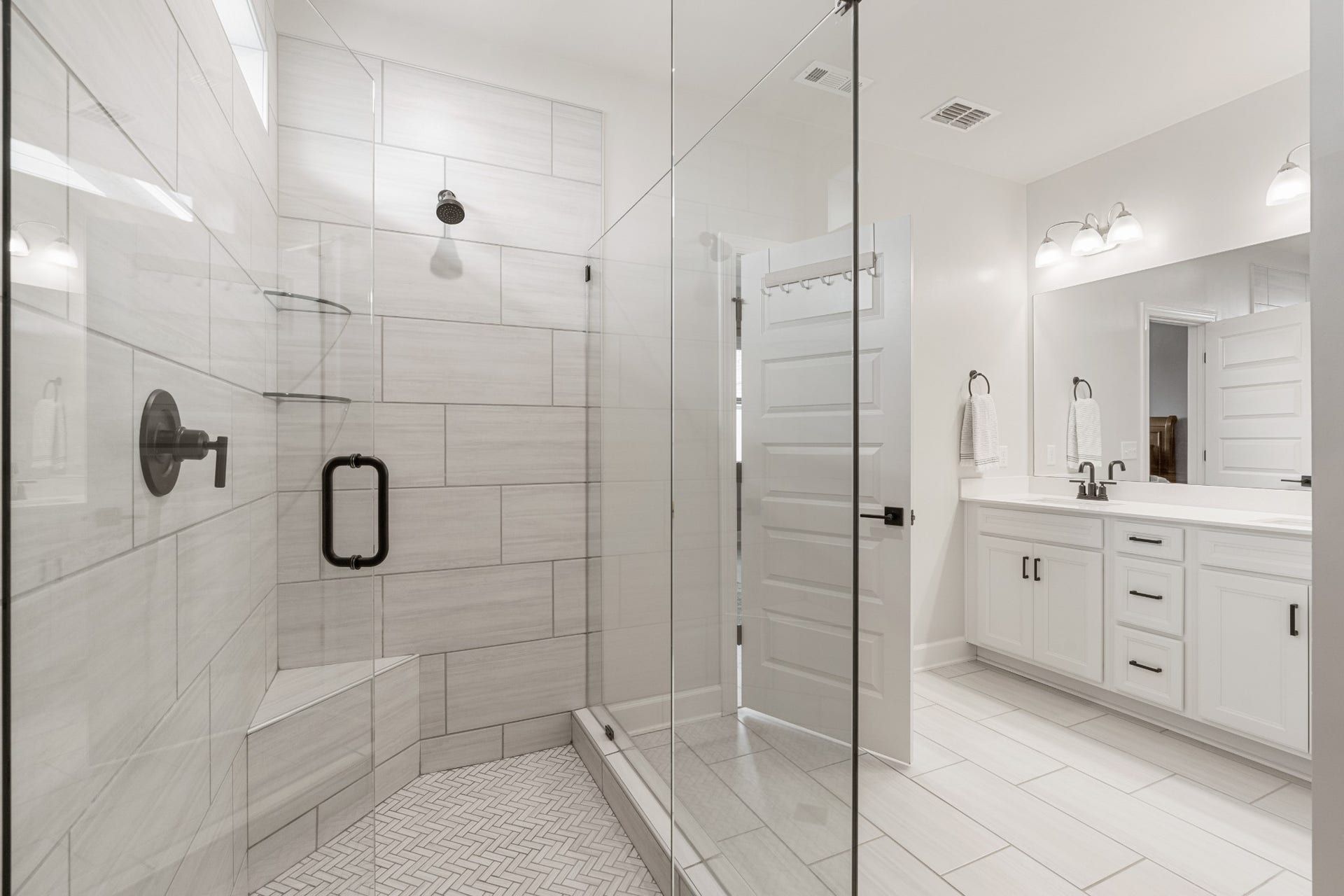 413 Mabels Way, Mount Juliet, TN 37122 The main-level primary bathroom includes dual vanities, a large tiled shower and beautifully selected finishes.
