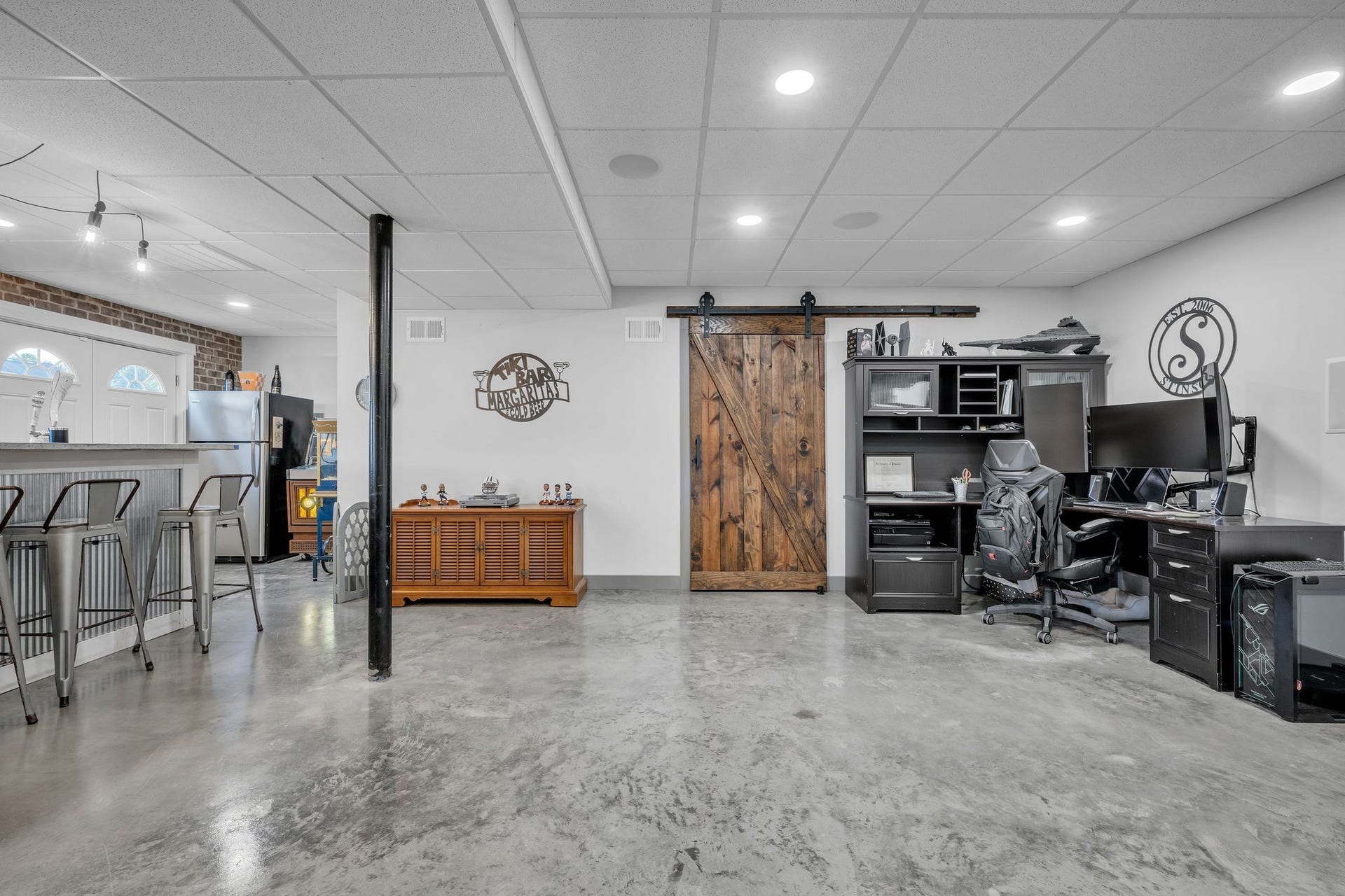 170 Lena Loop, Burns, TN 37029 Fully finished basement. Behind the barn door is a very large storage area with shelving for all of your seasonal decorations and more