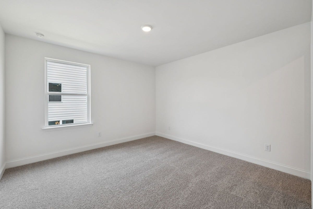 Macon bedroom 2. Photo is of similar home, same plan. Colors and options may vary.