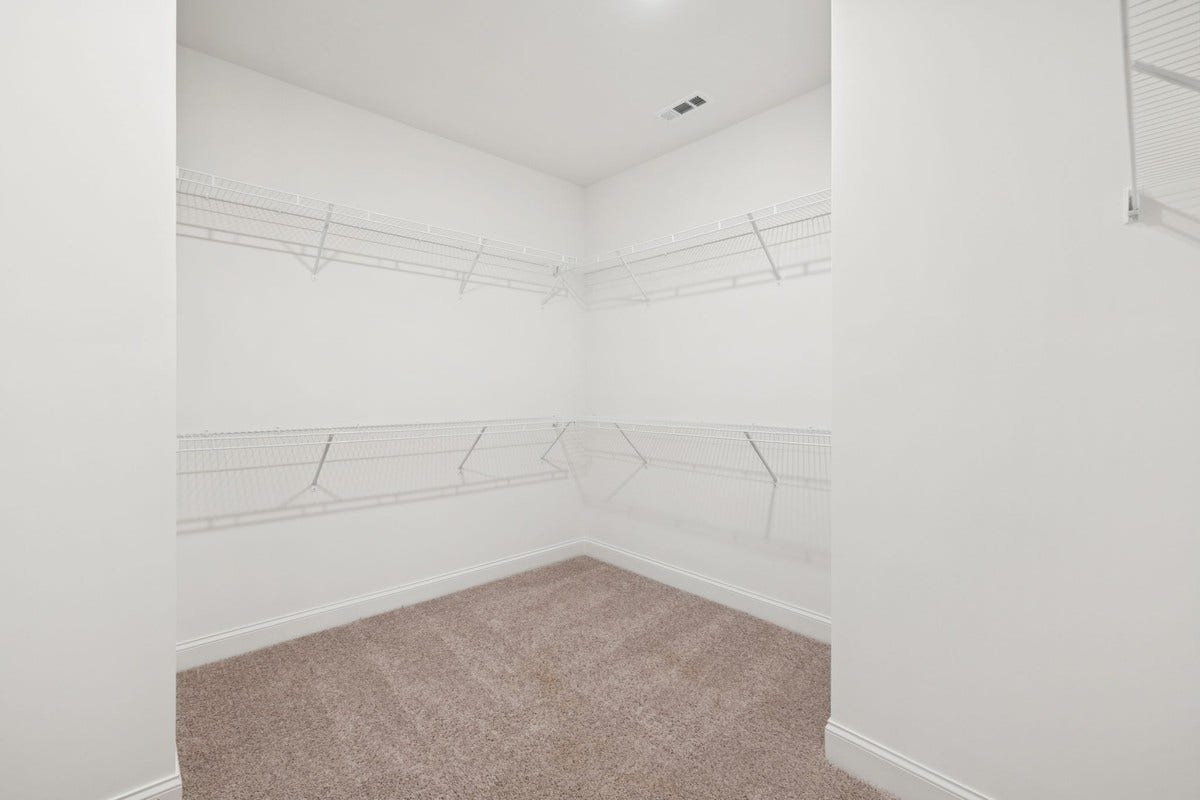 Macon primary walk in closet. Photo is of similar home, same plan. Colors and options may vary.
