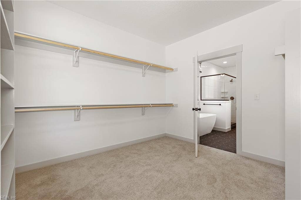 1st Floor Owner's Suite offers a large walk in closet with wood shelving.