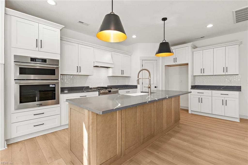 Stainless appliances include wall oven and microwave, gas range,  refrigerator, and dishwasher.