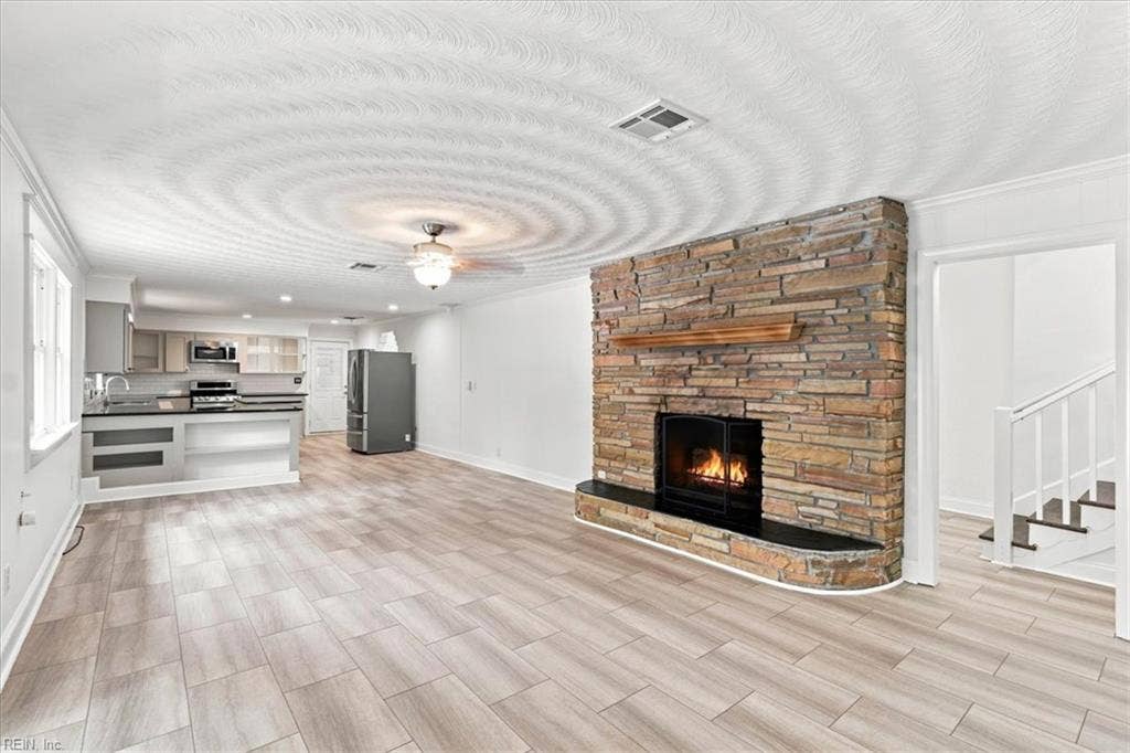 Beautiful open space with cozy fireplace ideal for family gatherings and entertaining.