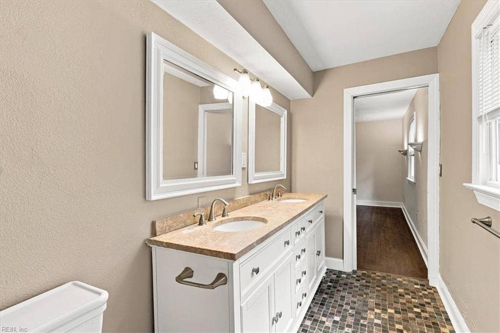 Double vanity ,  ceramic tiled floors in bath.