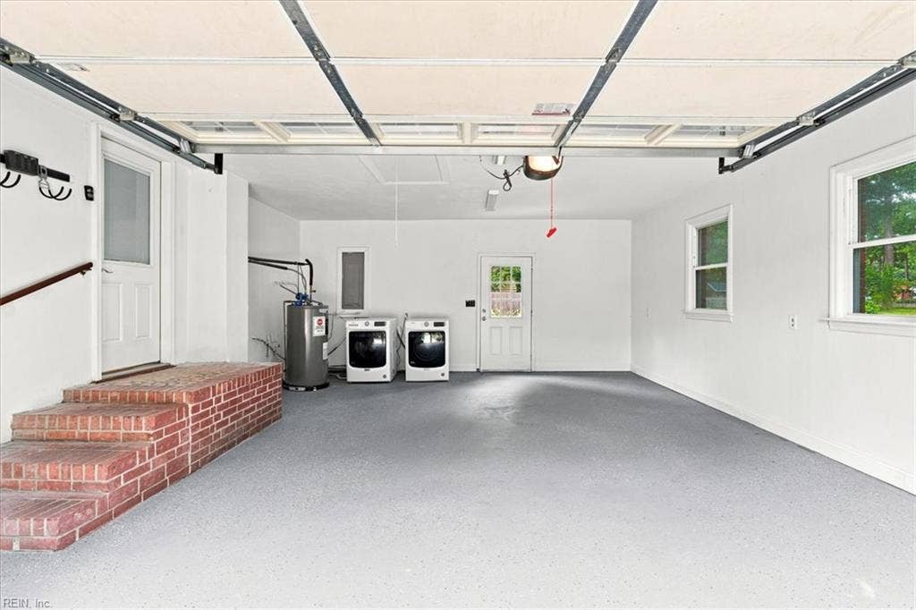Large garage with painted floor ,  overhead garage door opener